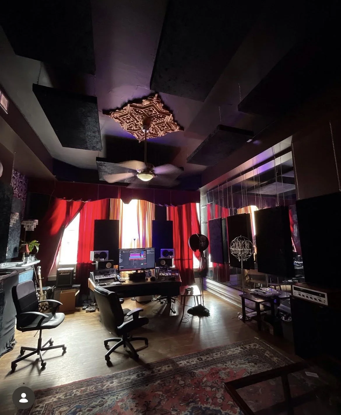 The control room at Manic Recording Studios, with acoustic treatment and red curtains.