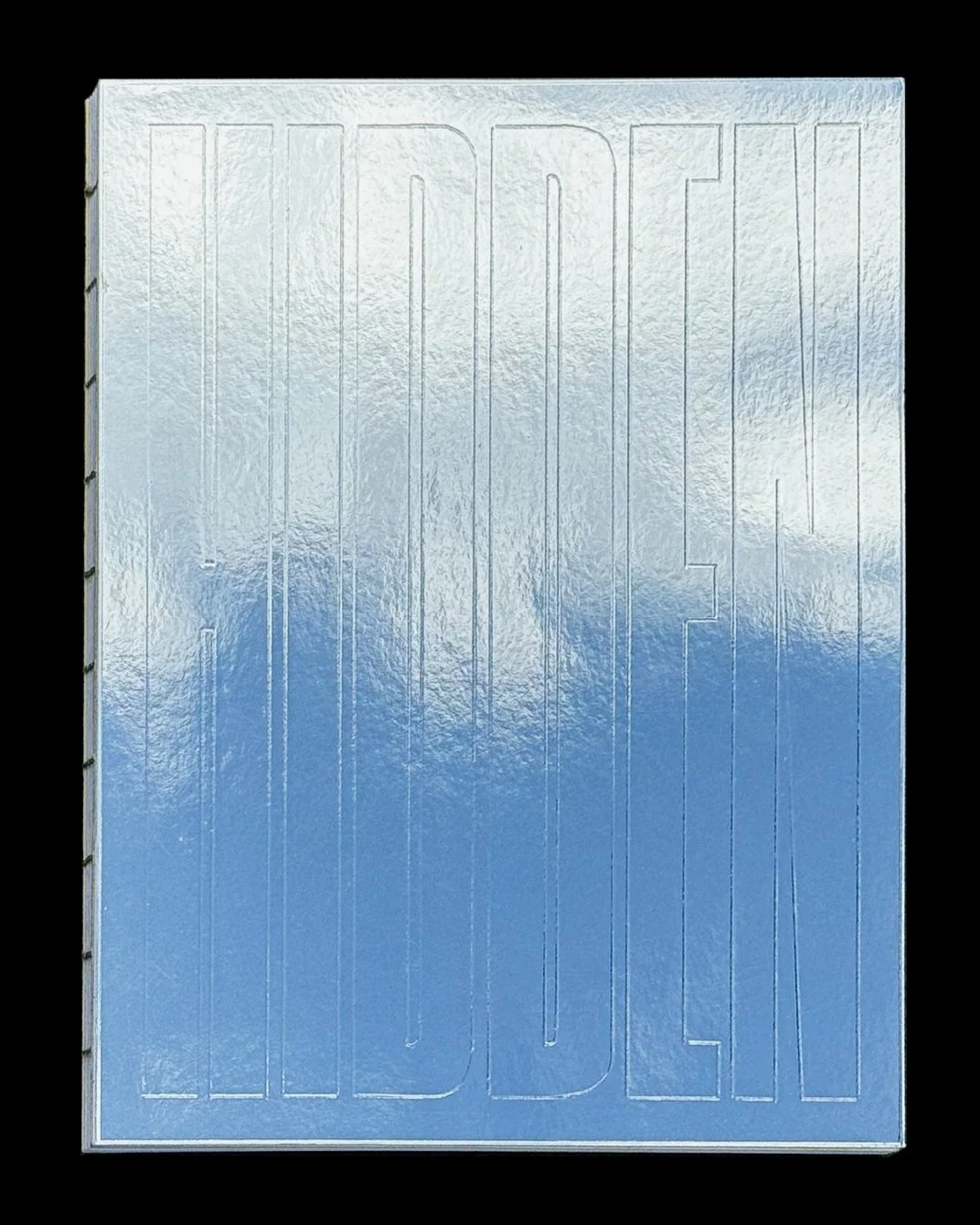 I used a metallic, reflective cardstock as the book cover and hand embossed it with the title, Hidden Light