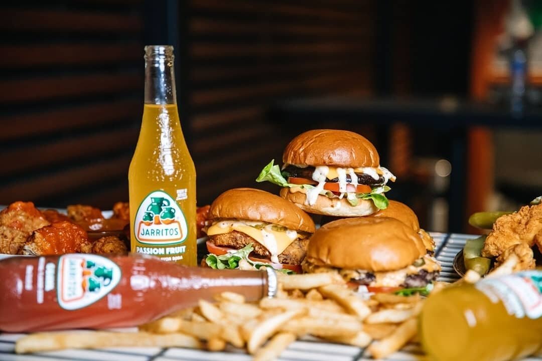 Happy Fry-day!! 🍟  Could you name a more dynamic duo then Jarritos &amp; Burgers?!🍔 👑. Transport your tastebuds to the warm bustling Americana pub scene with our mouthwatering spread of sides, wings &amp; burgers! Delivery via Deliveroo and Door D