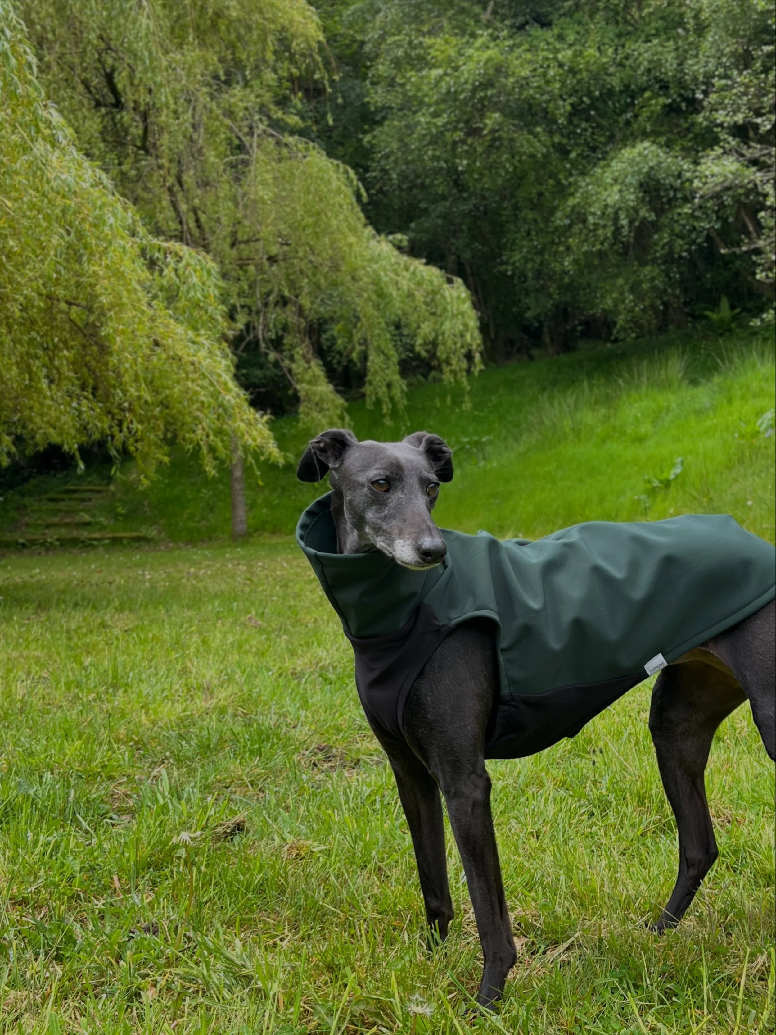 Poppy wears the Raincoat in forest green.