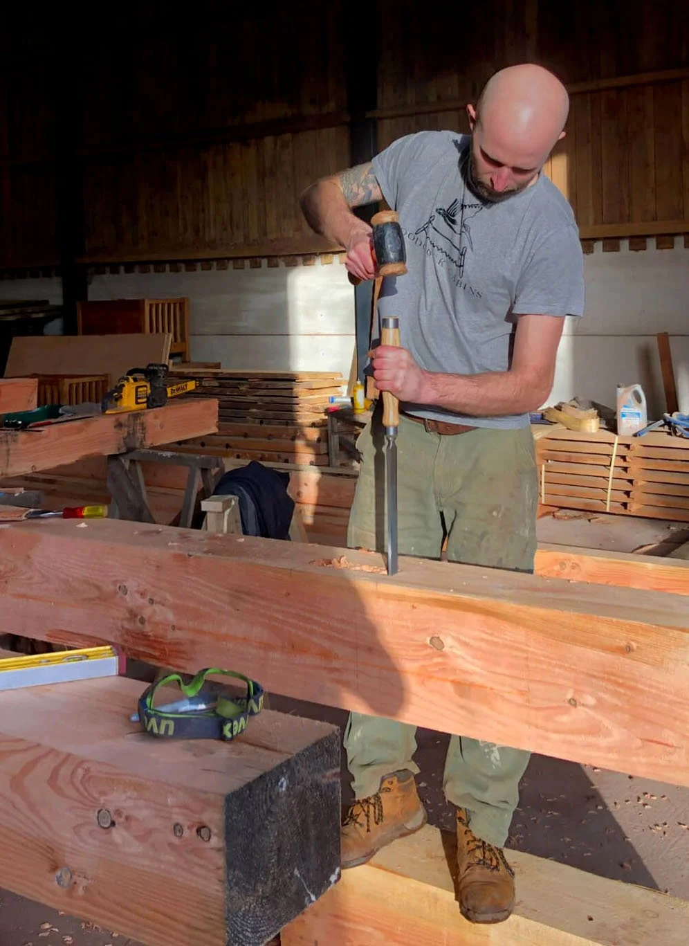 Alfie Woodcock Venner using a mallet and a chisel on a piece of wood