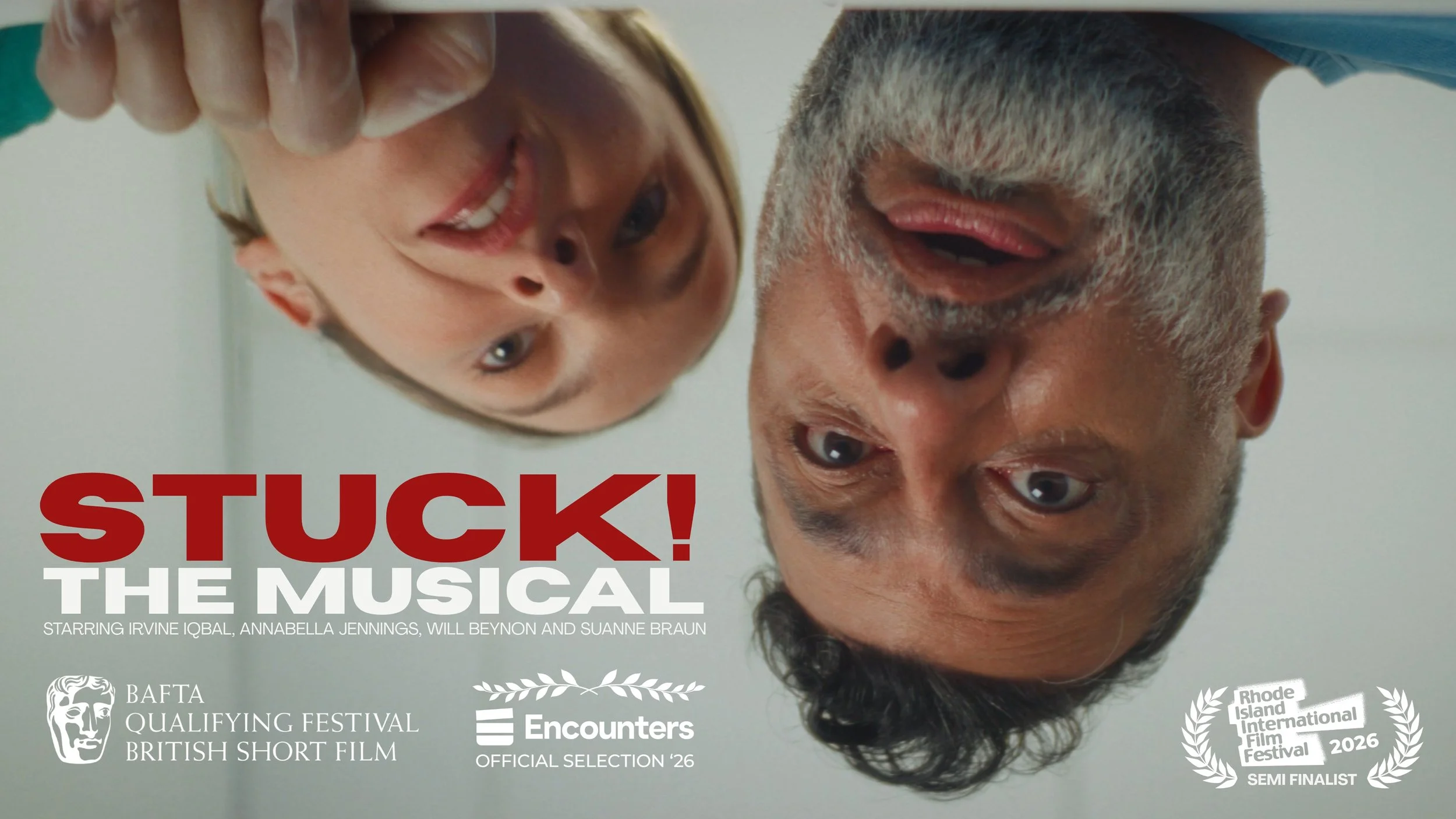 Cover of a musical featuring two performers, a woman and a man, both looking upside down at the camera with surprised expressions. The title 'STUCK! THE MUSICAL' is prominently displayed in red and white text at the bottom. Additional text mentions cast members and festival accolades.