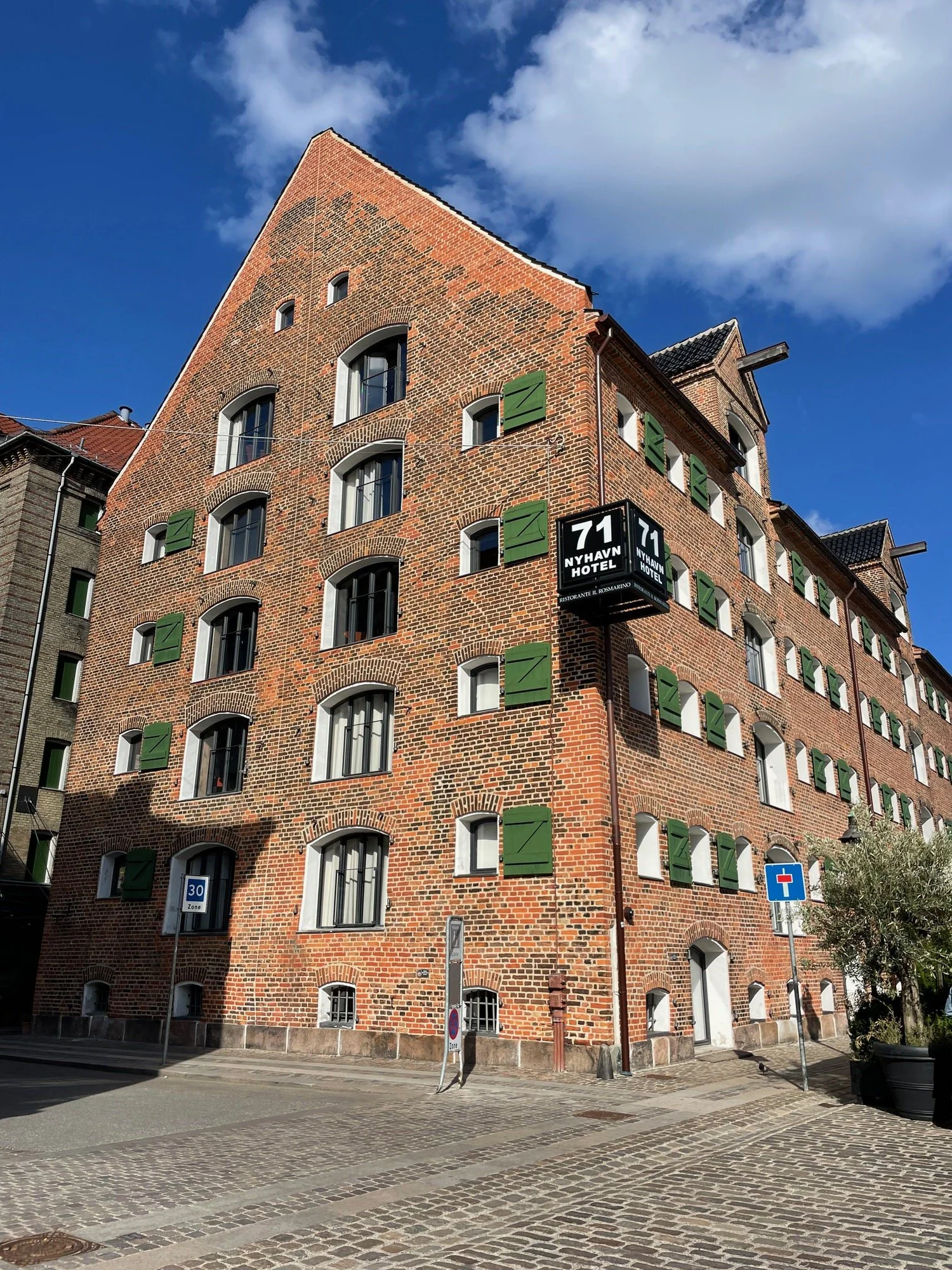 71 Nyhavn, a former warehouse turned hotel. Brick exterior with beautiful interior with rustic touches, art pieces and exposed beams.