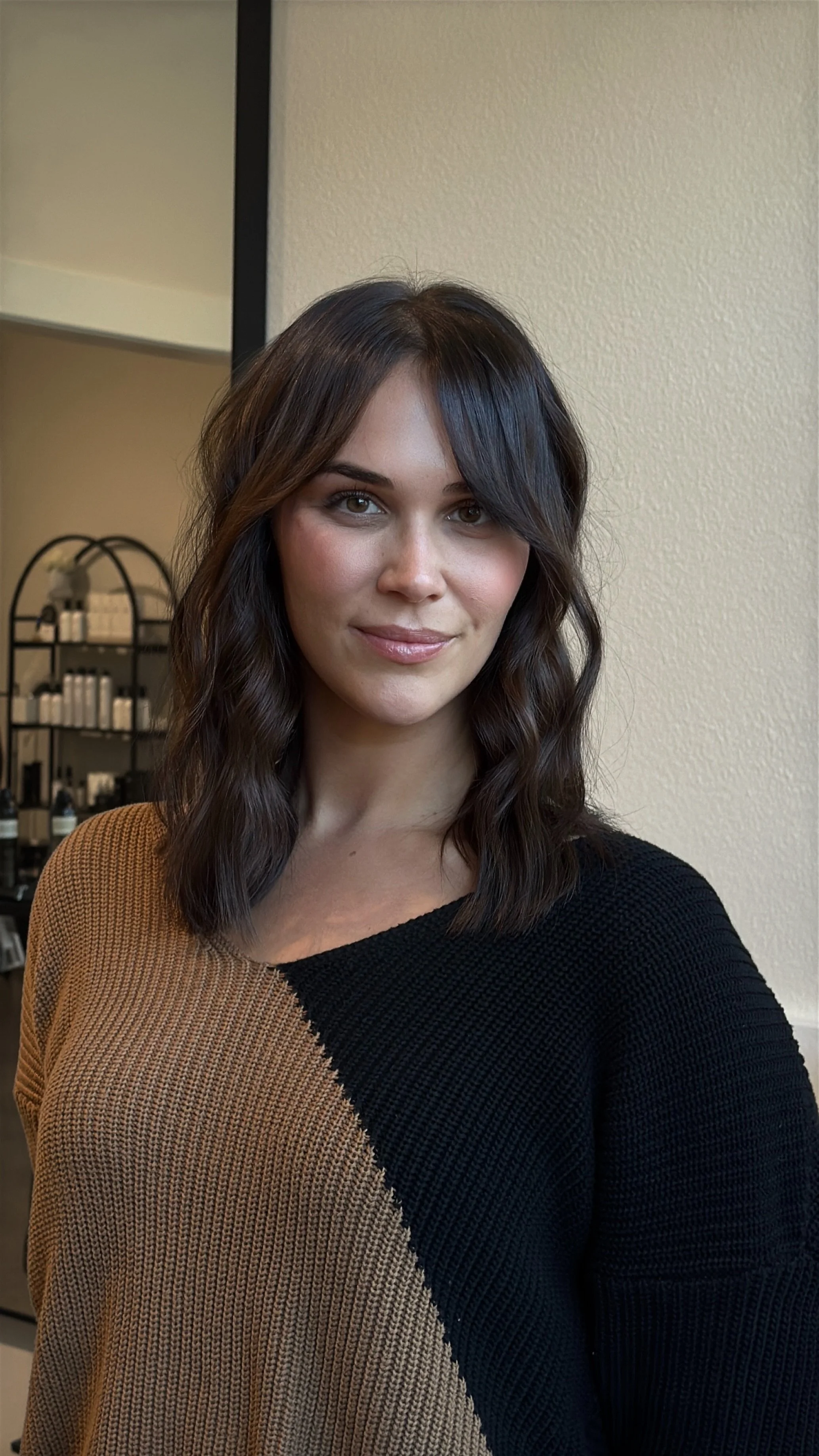 Mid length hair extensions styled with loose curls at West Linn salon