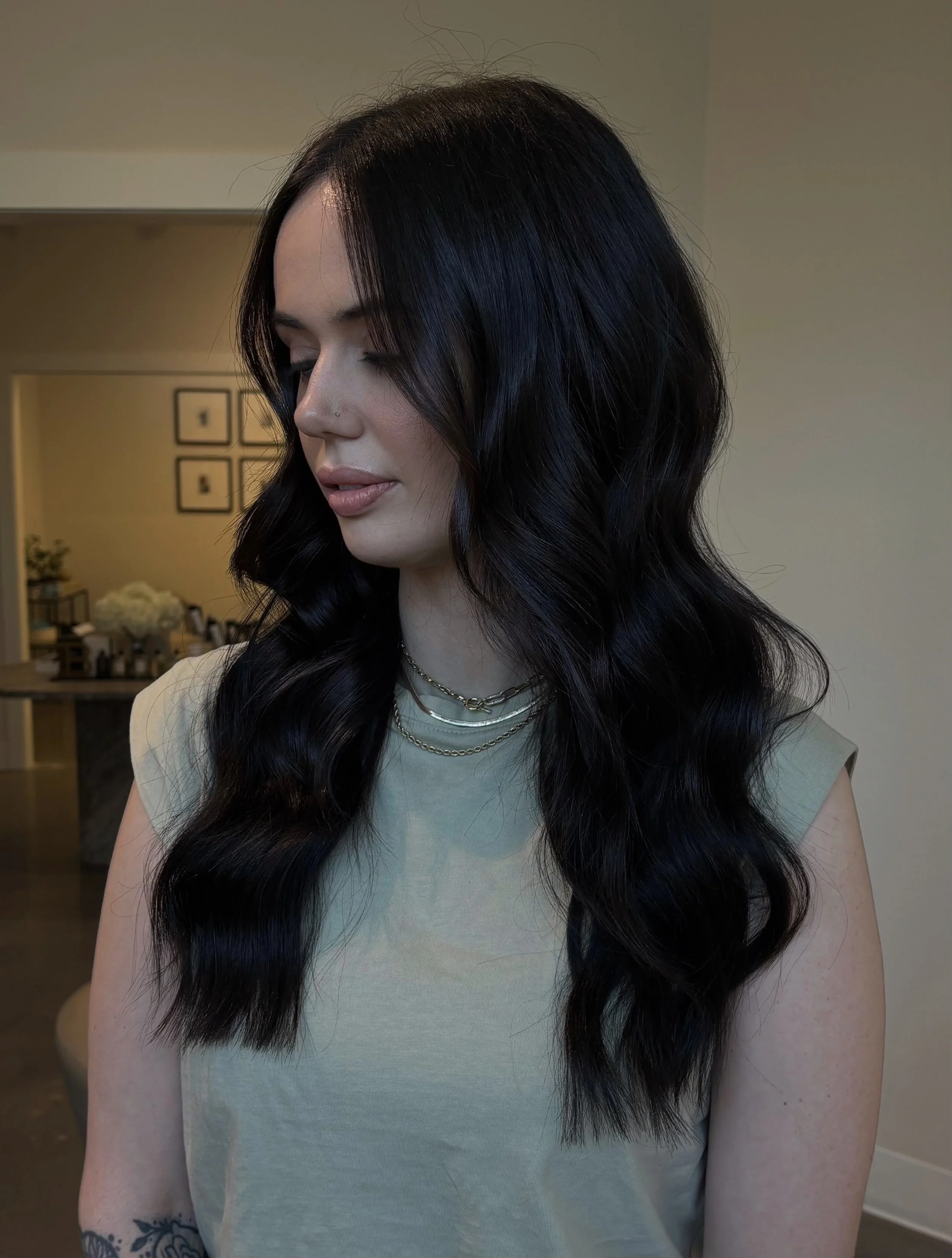 Lightweight hair extensions styled with loose curls at West Linn salon