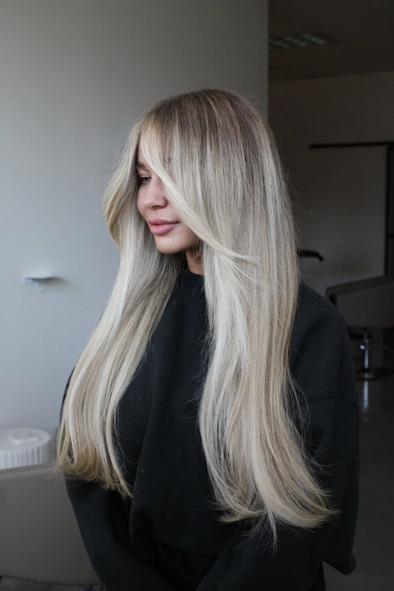 Straight hair extensions and blonde color correction with bright face frame and toned ends in West Linn, Oregon.