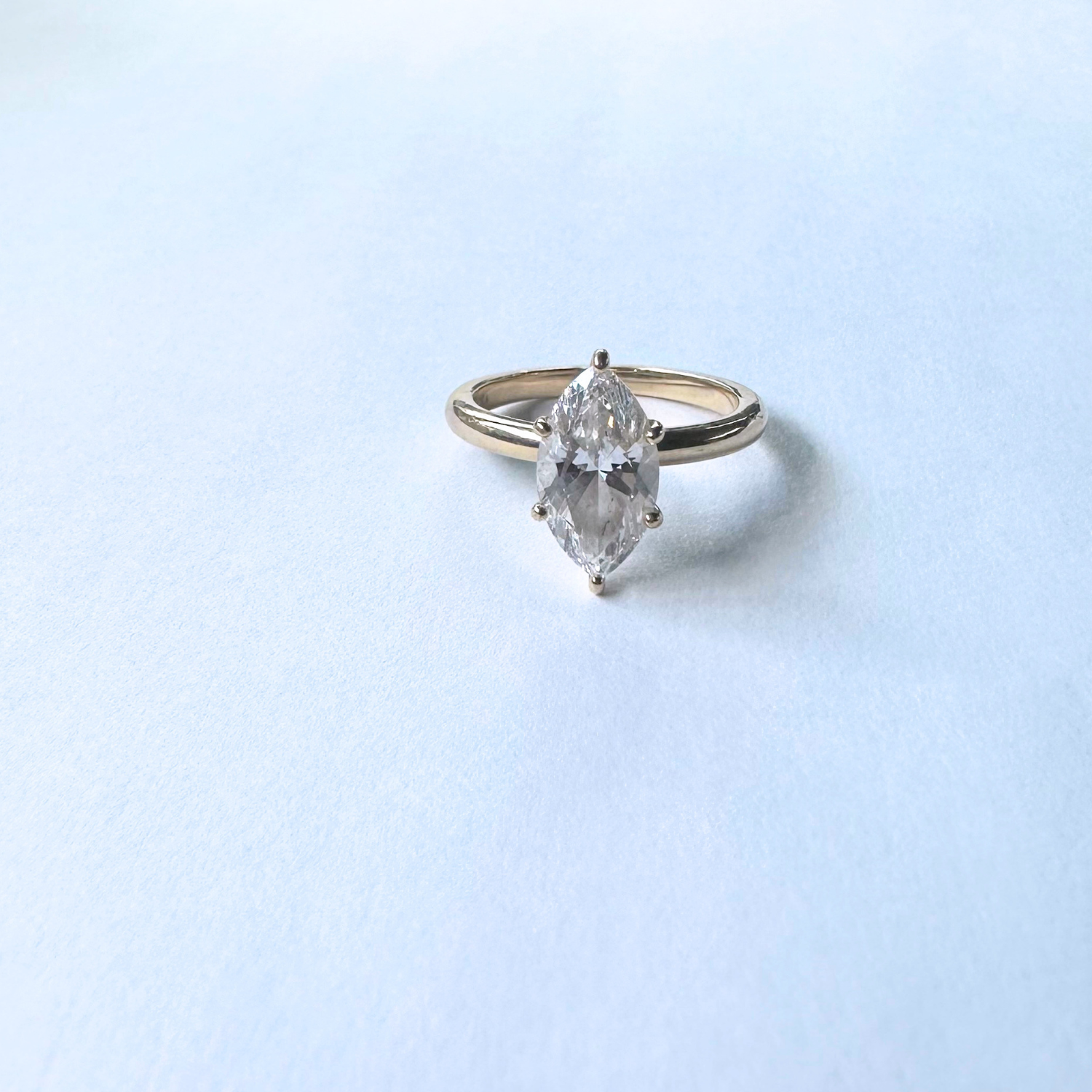 Preloved marquise-cut engagement ring in 14k yellow gold