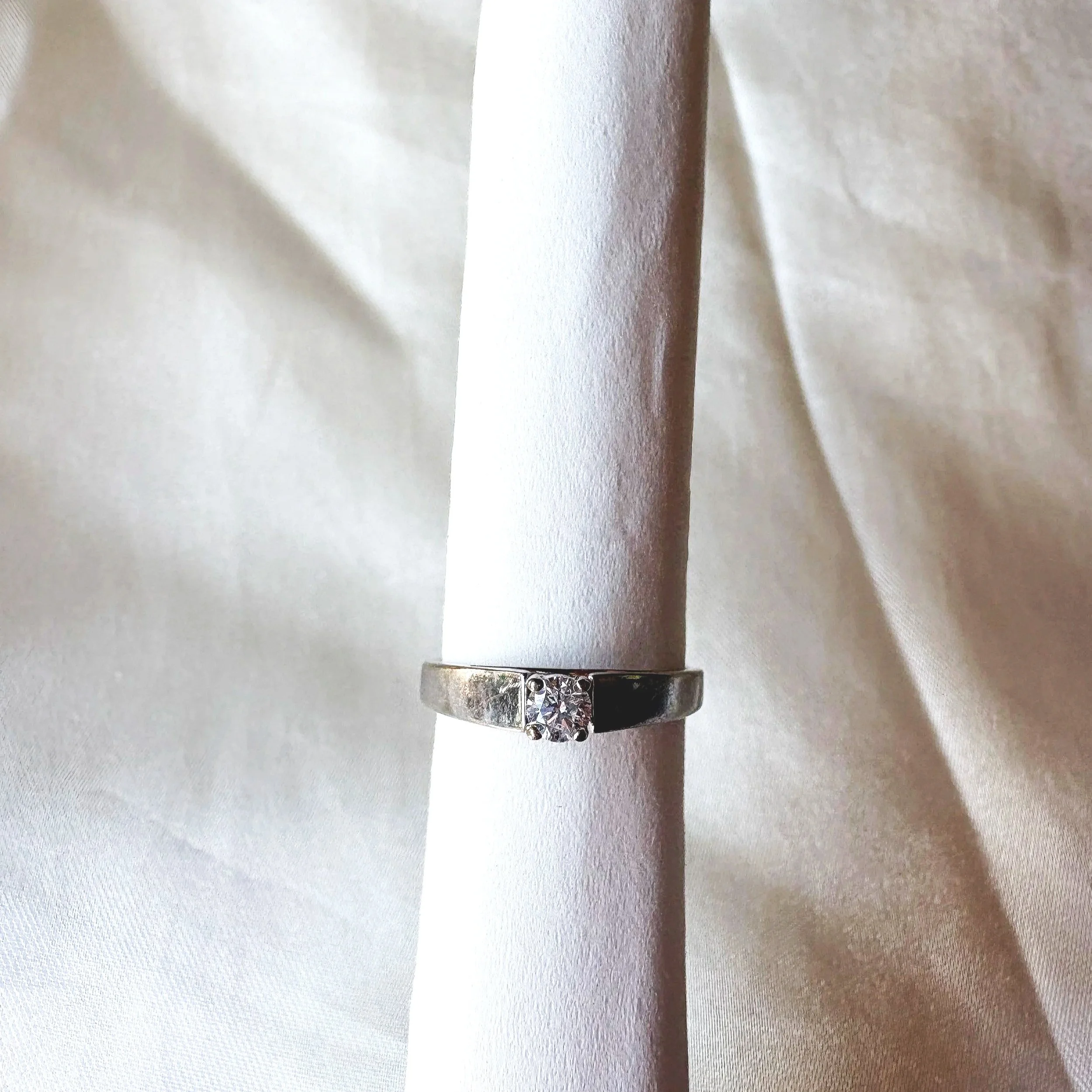 View of 14k white gold engagement ring with small round natural solitaire diamond