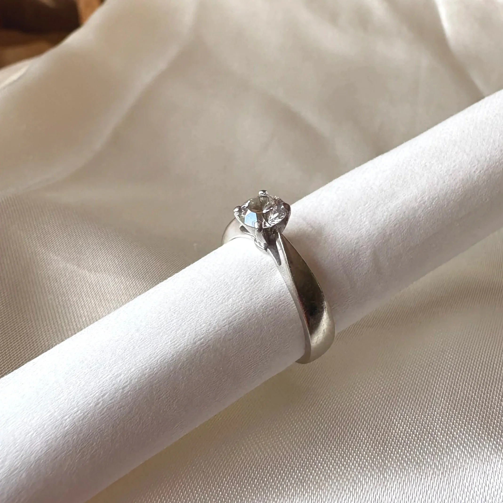 slanted view of previously owned white gold solitaire engagement ring
