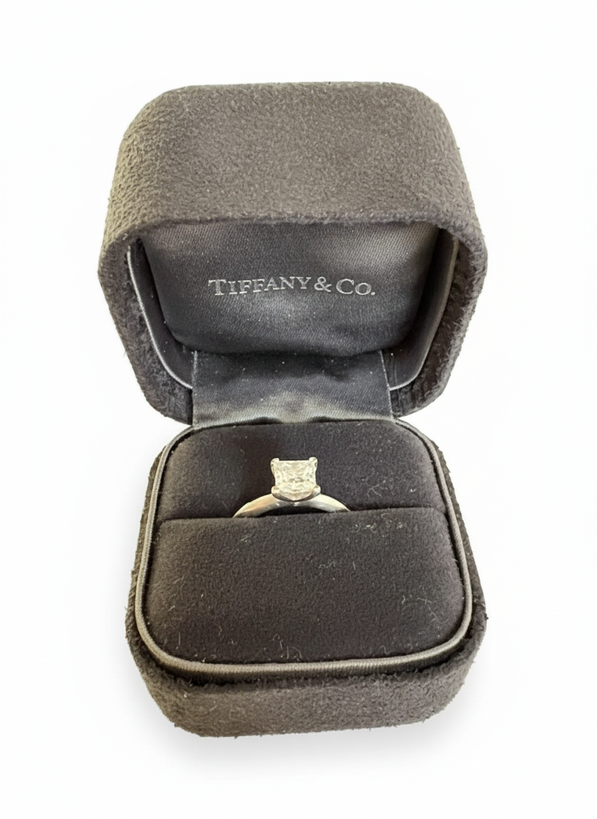 Close-up of a Tiffany Blue ring box with a white ribbon, sitting on a clean white background