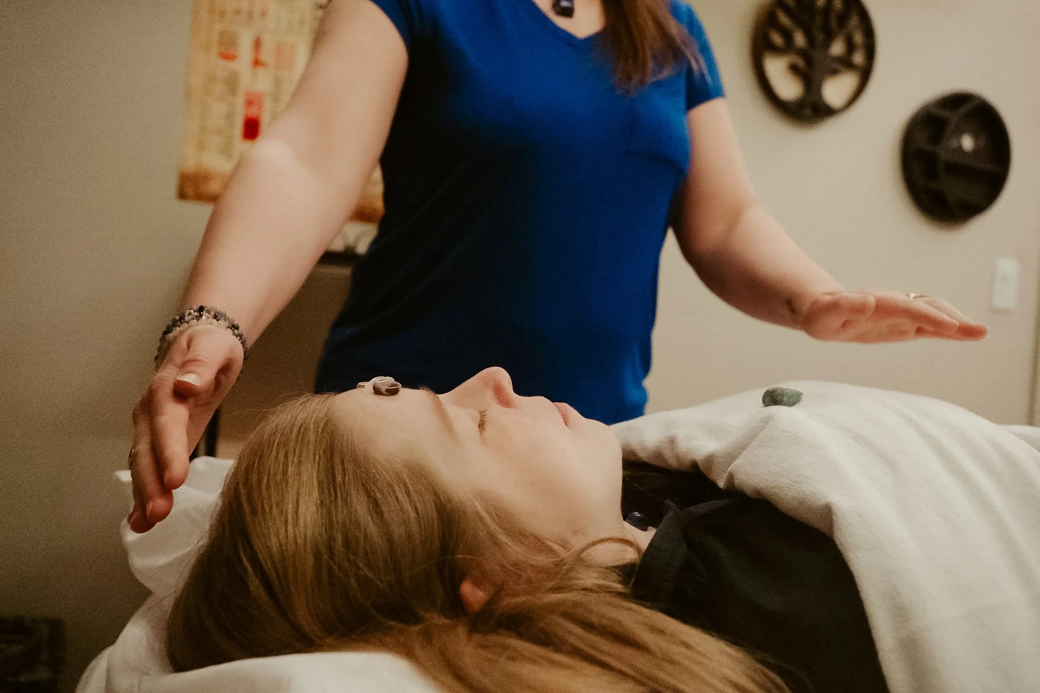 Master Reiki Healer Angela Goebel performing traditional Reiki on her client.