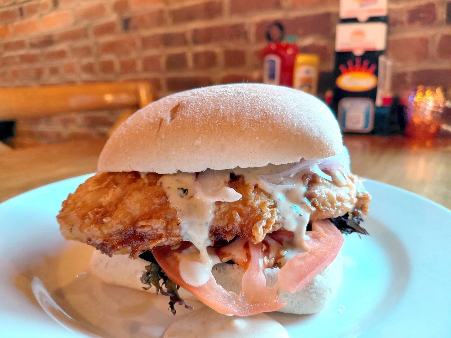 Eat Crow WEEKLY SPECIAL &bull;🐔 Crispy Chicken Alfredo Sandwich 🥪: Hand-battered fried chicken on a chibatta bun with house-made Alfredo sauce, lettuce, tomato, and red onion - $19, comes with a side. Available December 15-21.