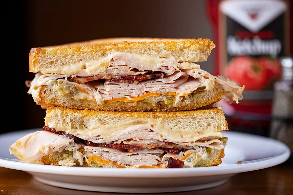 ALBUQUERQUE TURKEY! house-cut turkey breast, bacon, cheddar, pepper jack, green chili and deep fried garlic mayo on sourdough.