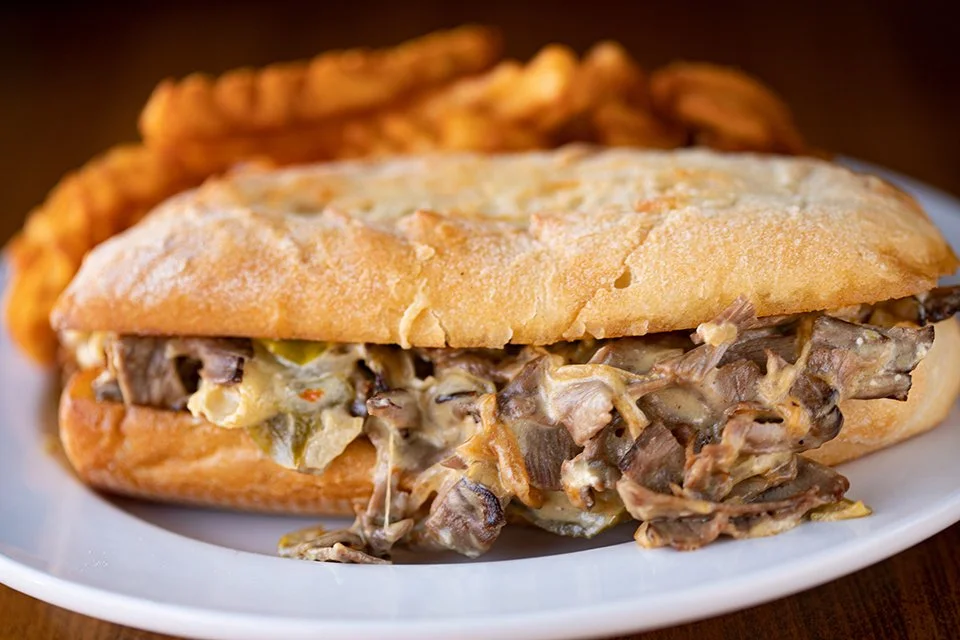 PHILLY: house-cut roast beef with saut&eacute;ed onions and green peppers, cream cheese and gouda jalape&ntilde;o cheese sauce on a hoagie!