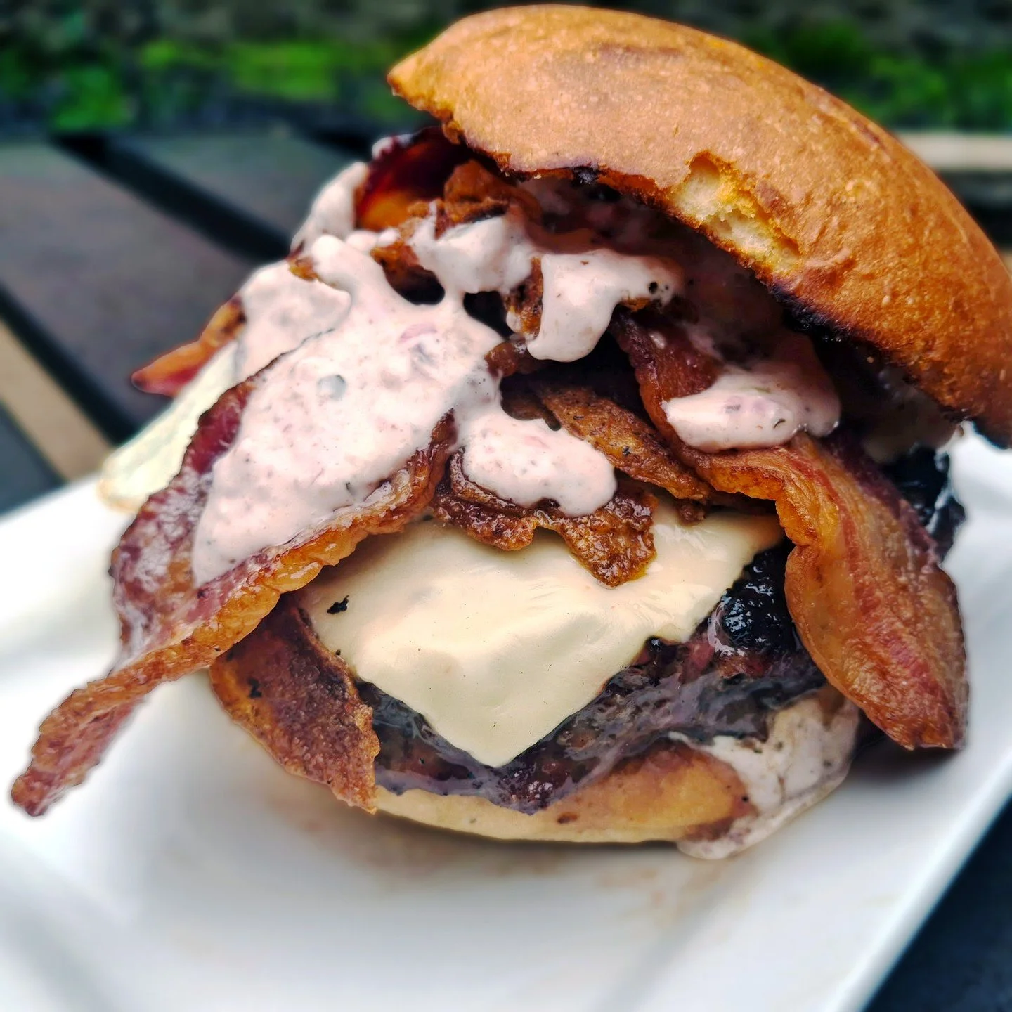 Eat Crow WEEKLY SPECIAL &bull; ☀️ Good Morning Burger 🍔: A half-pound beef patty topped with green chile mayo, an over-easy egg, pepper jack cheese, fried onions, and bacon, all served on a brioche bun - $19, includes a choice of side. Available Apr