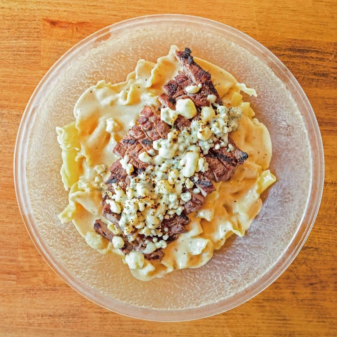 BLACK &amp; BLUE MAC: Our original mac &amp; cheese with blackened sirloin covered in gorgonzola with fried onions. Full menu LINK IN BIO.