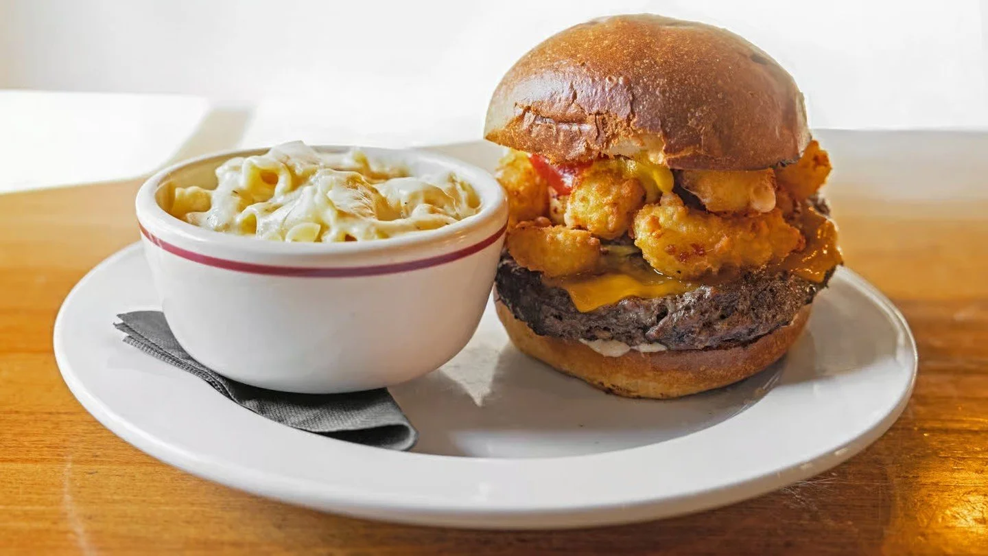 WISCONSIN BURGER: Choose a half-pound butter burger or veggie patty with cheddar and fried cheese curds, topped with ketchup, mustard, and garlic-pepper mayo on a brioche bun and pictured here with a side of our Mac &amp; Cheese.
The full menu is at 
