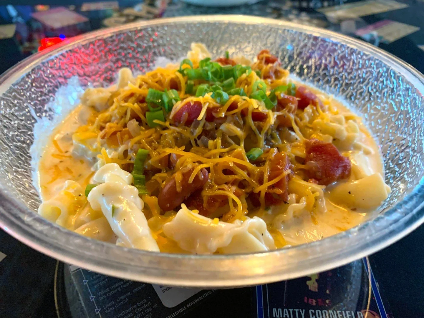 VEGGIE CHILI MAC: Our original mac &amp; cheese with veggie chili, cheddar, and jalapeno-sriracha sour cream, garnished with green onion.