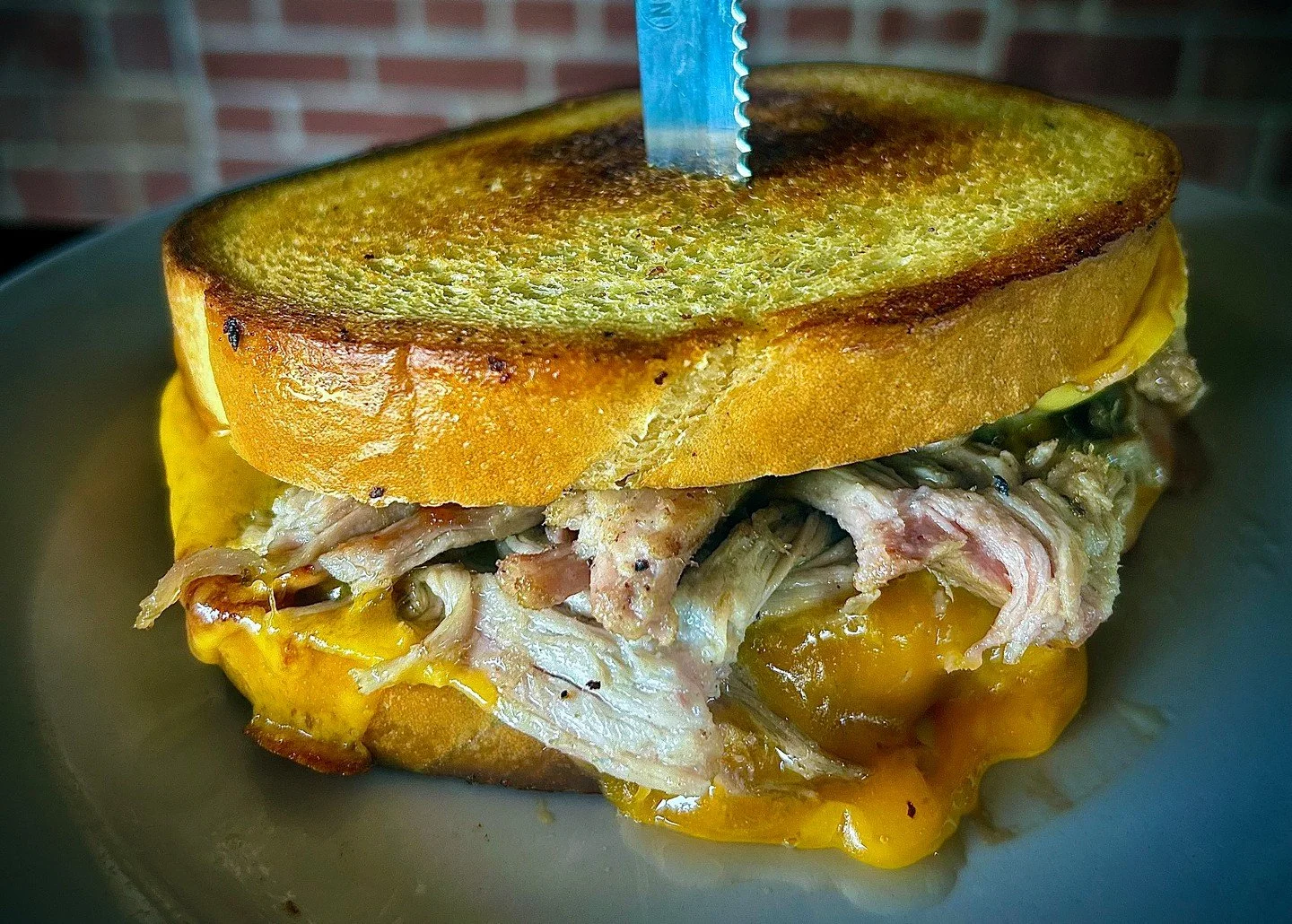 PULLED PORK GRILLED CHEESE: pulled pork with cheddar, smoked gouda, marinated red onions, pickles, and BBQ sauce on sourdough. 

#EatCrowSTL #PulledPork #GrilledCheese #ComfortFood #SoulardEats #StLouisFood #STLFoodie #BarFood #NewMenu