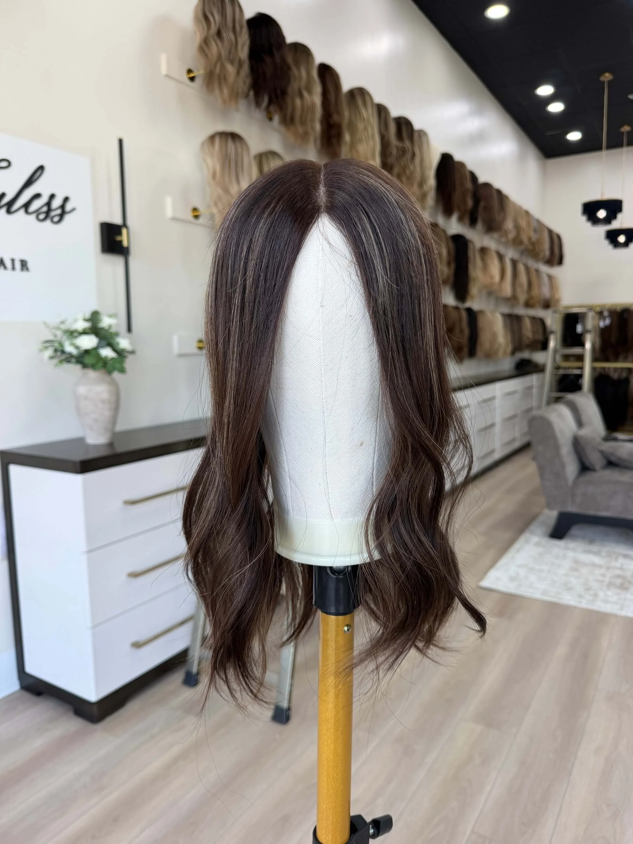 18-inch brown human hair topper with a Feather Silque base
