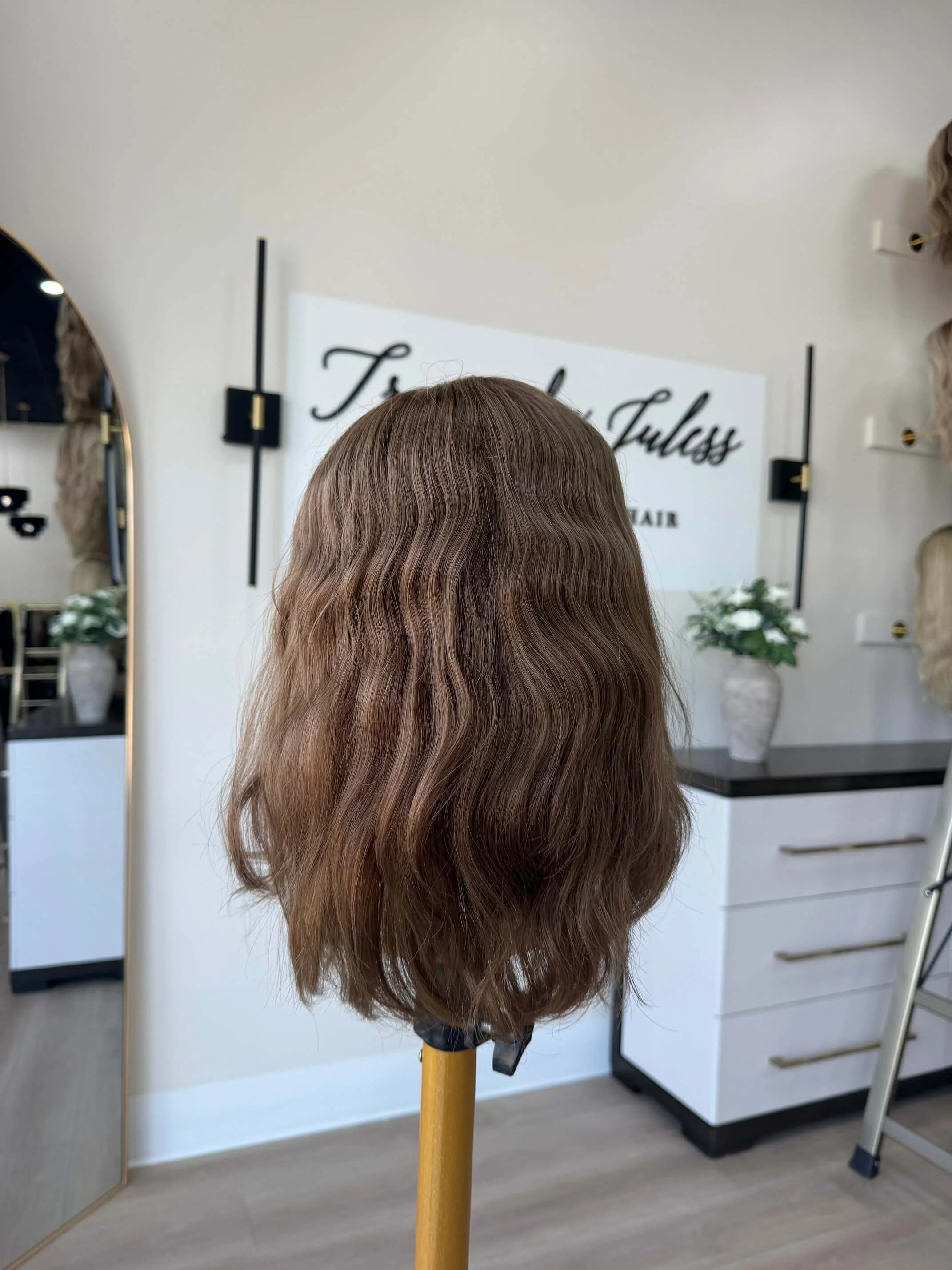 24-inch brown human hair wig with a Feather Silque base