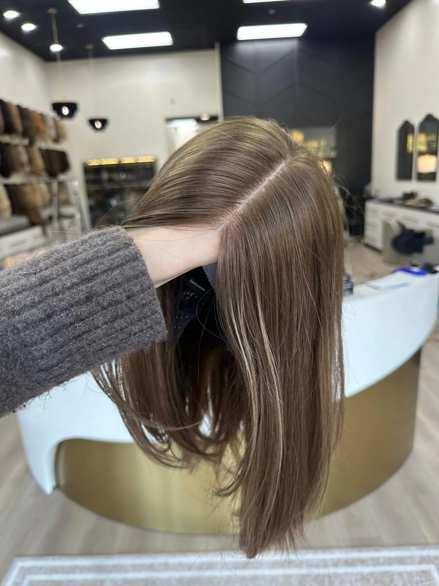 18-inch bronde human hair wig with a Feather Silque base