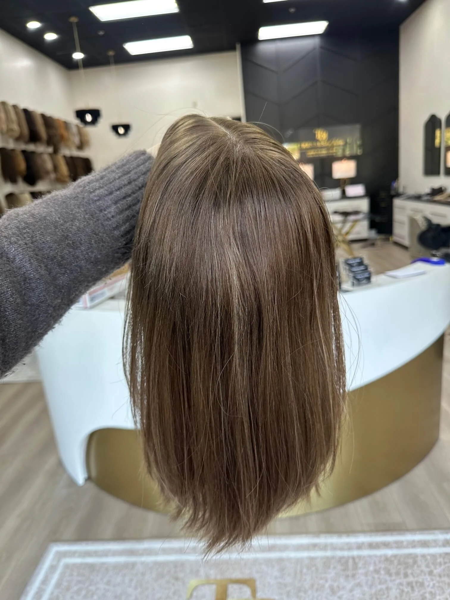 18-inch bronde human hair wig with a Feather Silque base