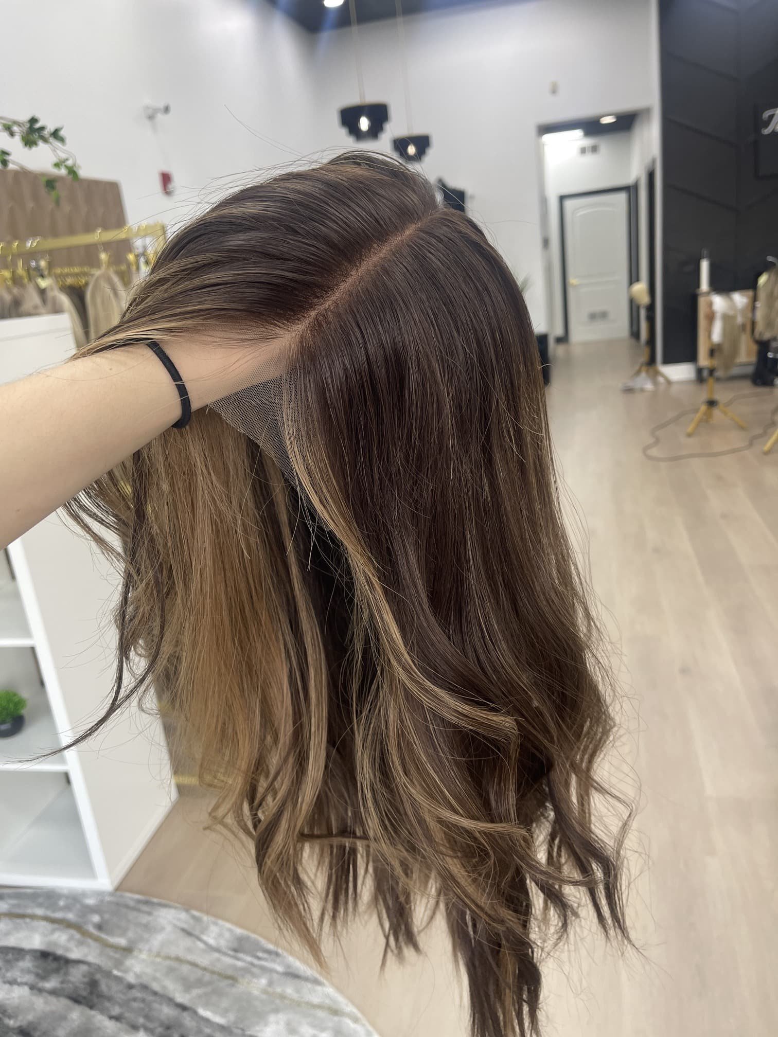 _Elegant_brunette_wig_with_natural_highlights__styled_on_a_woman_in_Sacramento_Studio___.jpg