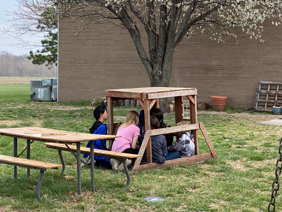 Always finding another use for different things. A sweet moment captured of our middle schoolers gathered together inside of part of an Early Childhood play structure.