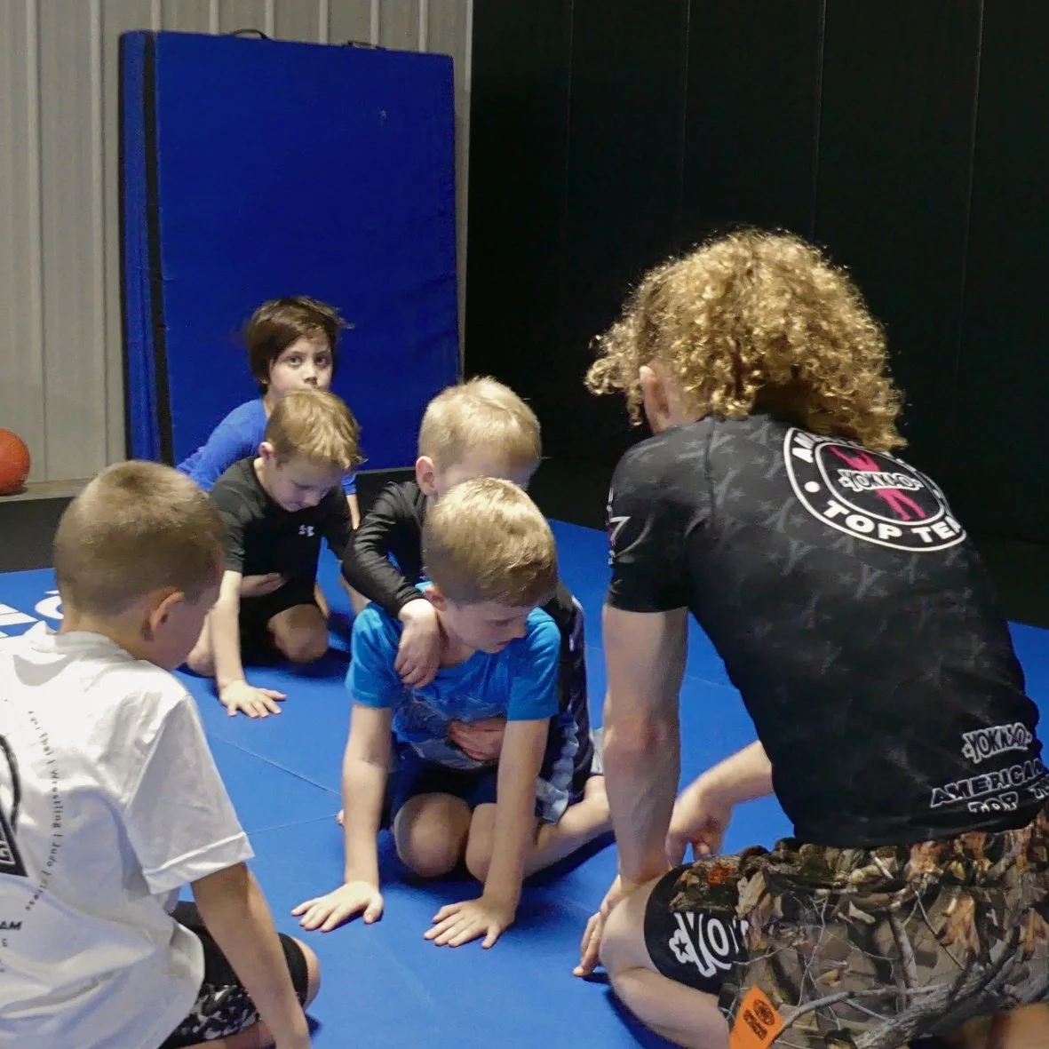 Kids Wrestling, a group of children being coached in a kids wrestling class