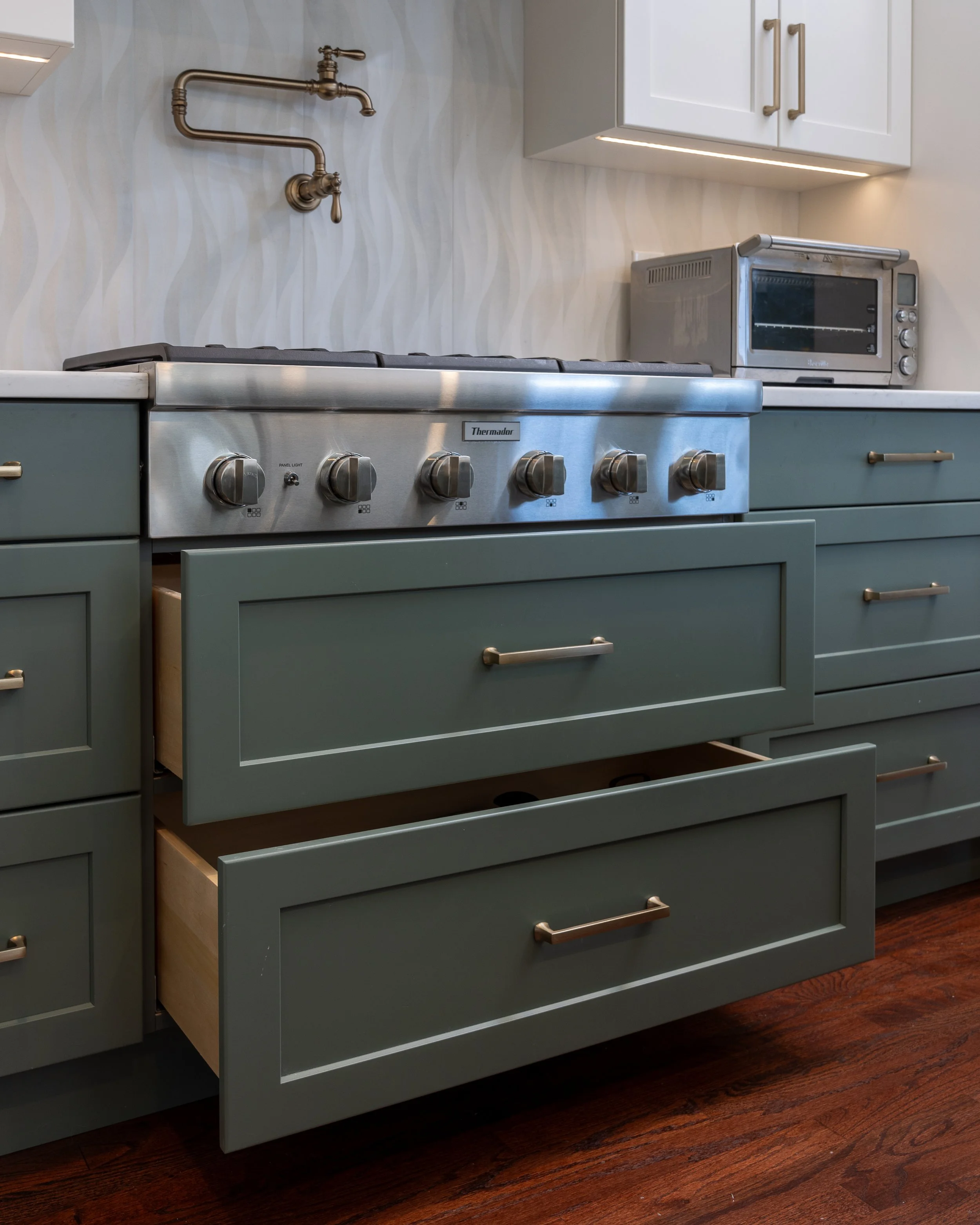 green drawers under the range in a kitchen