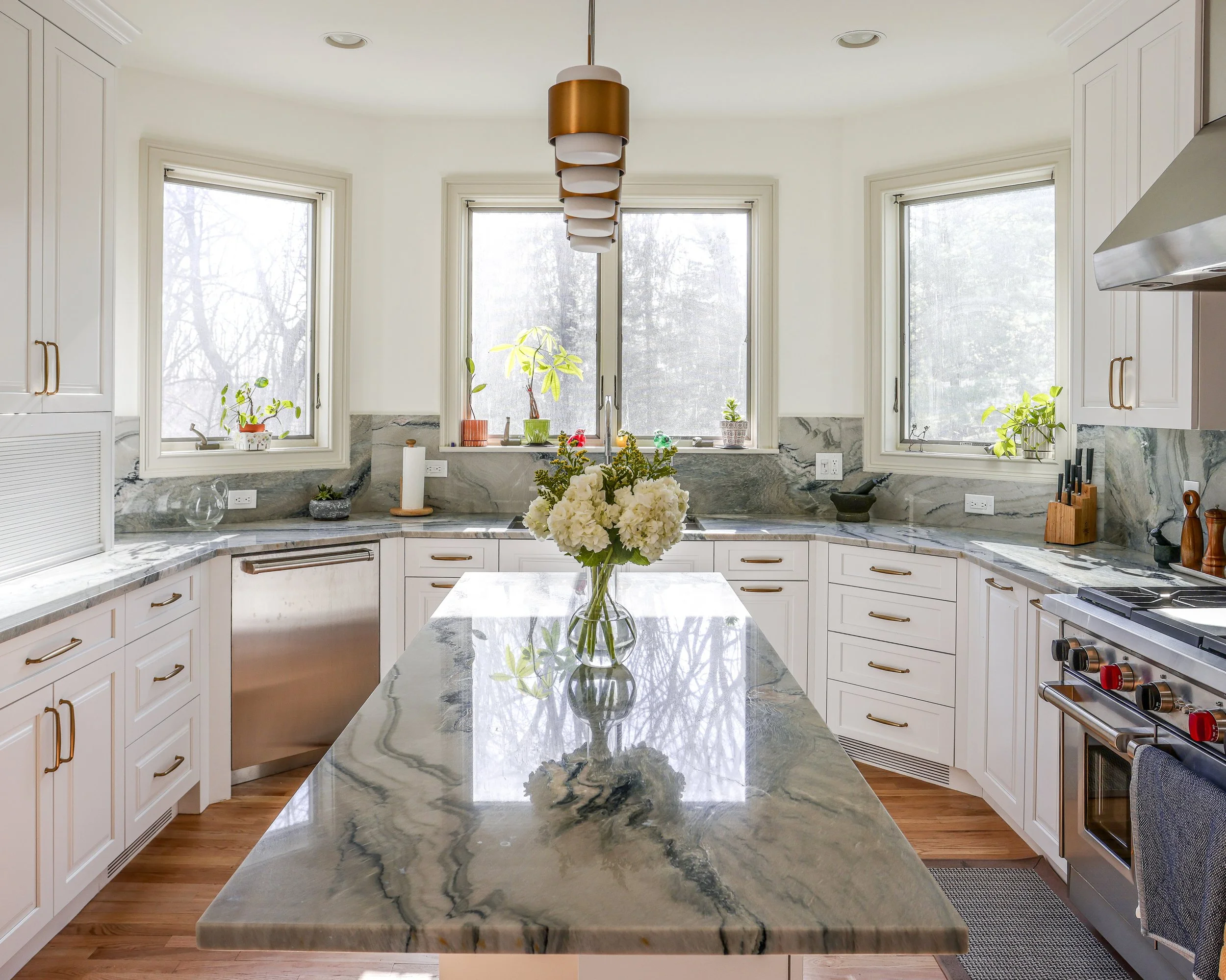 a bright white kitchen with large window on one side