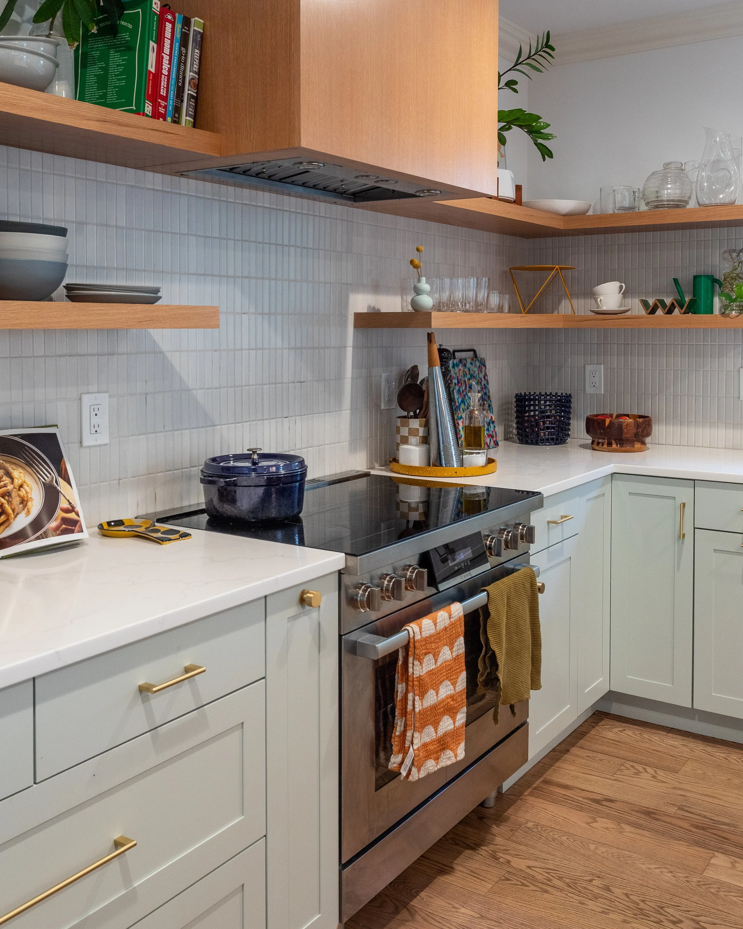 close up of a stainless stove with a wooden range above it