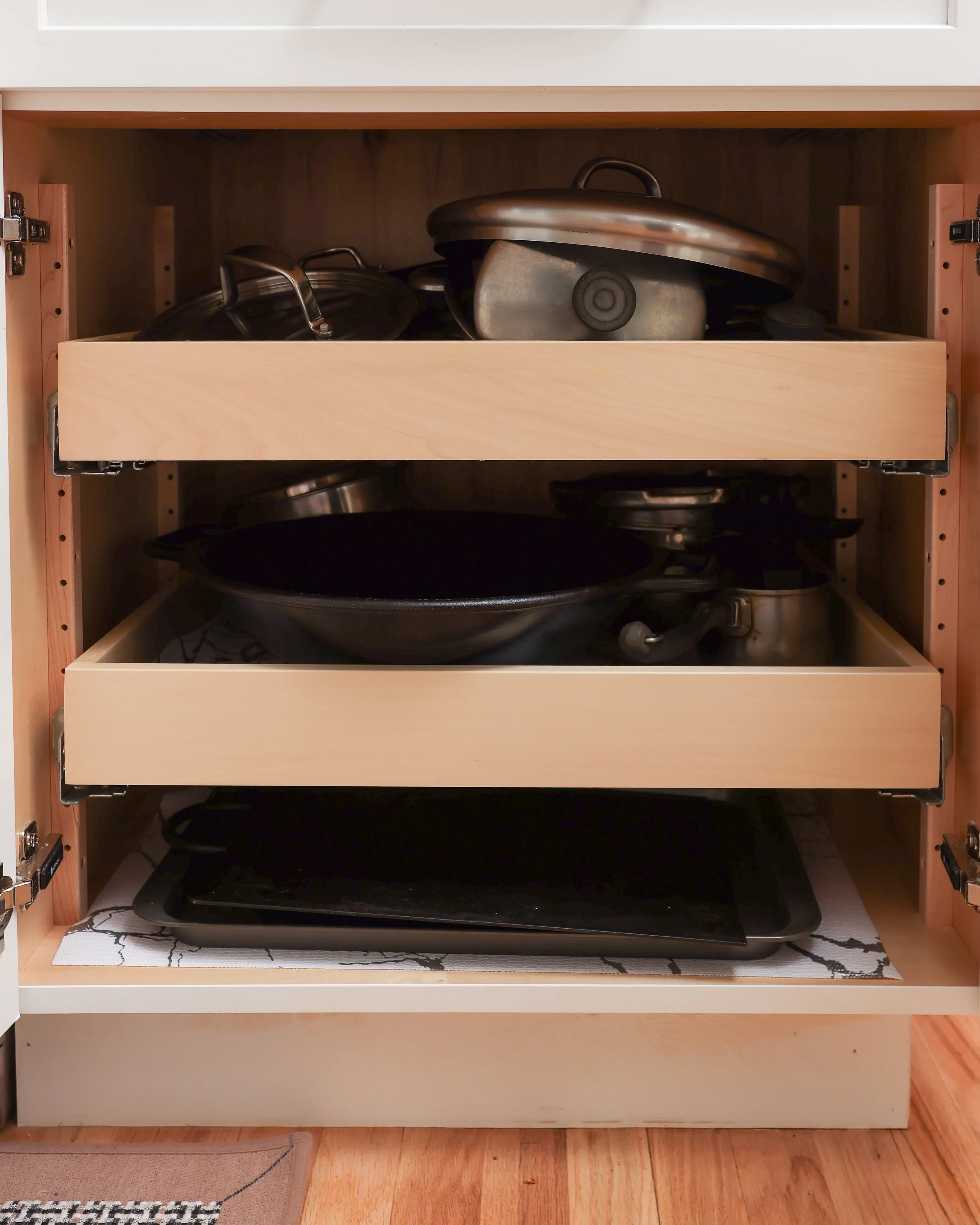 a cabinet with pull out drawers