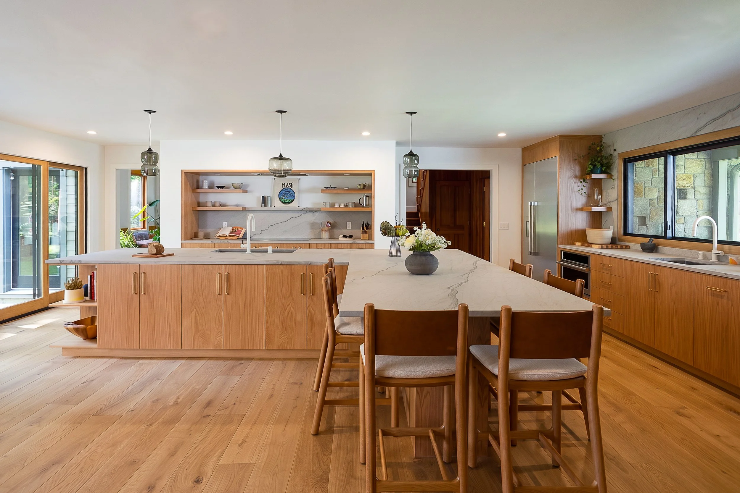 a large kitchen with wood floors and wood cabinets