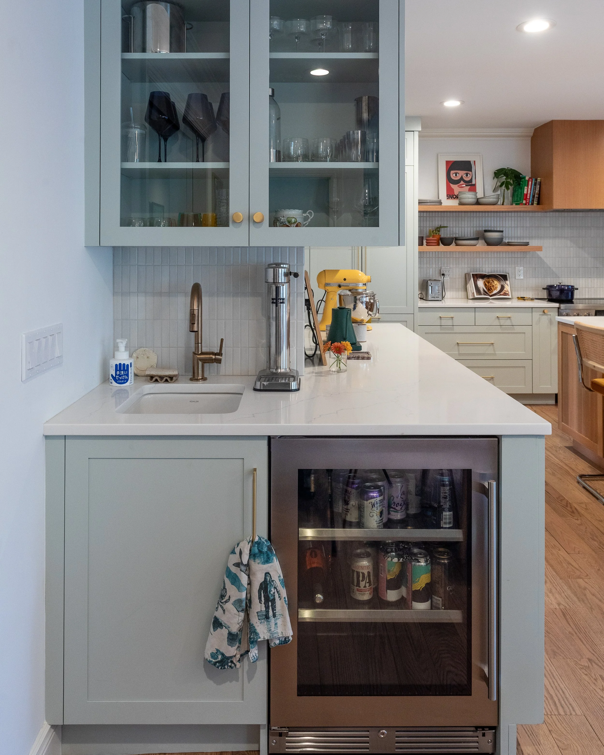 cabinets with glass doors, a built in fridge and sink