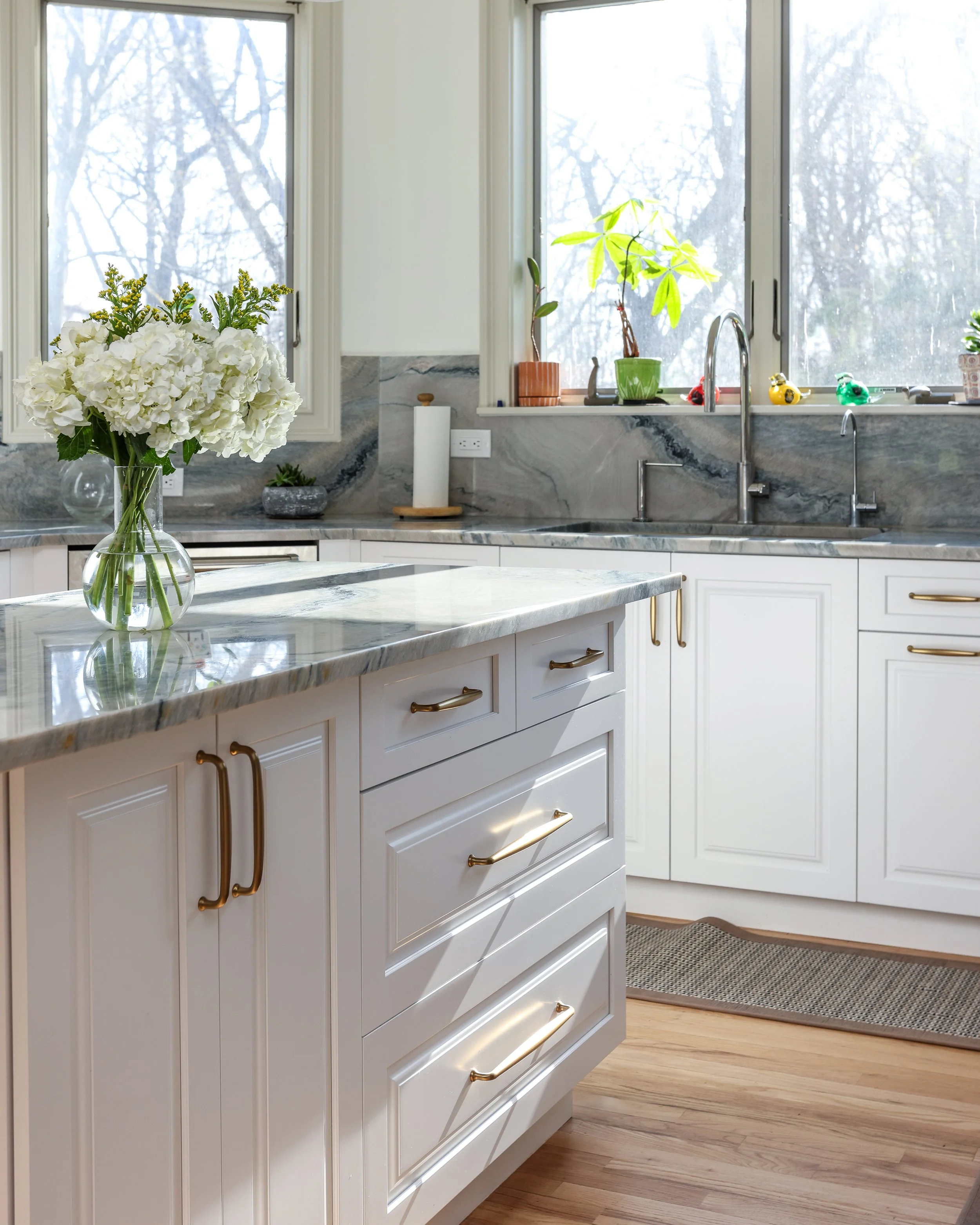 lower cabinets under an island with grey stone