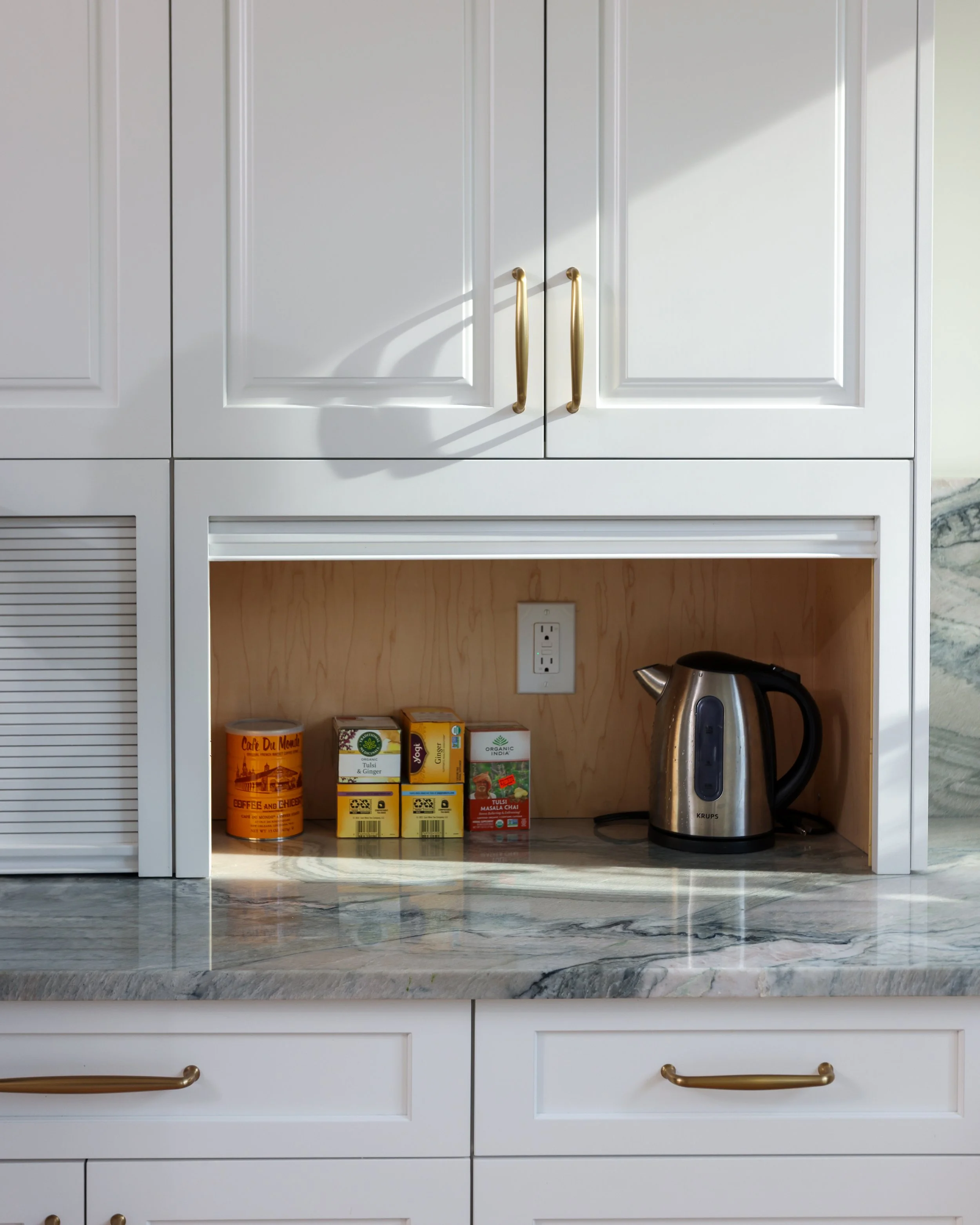 a cabinet with a door that slides up to reveal products inside.