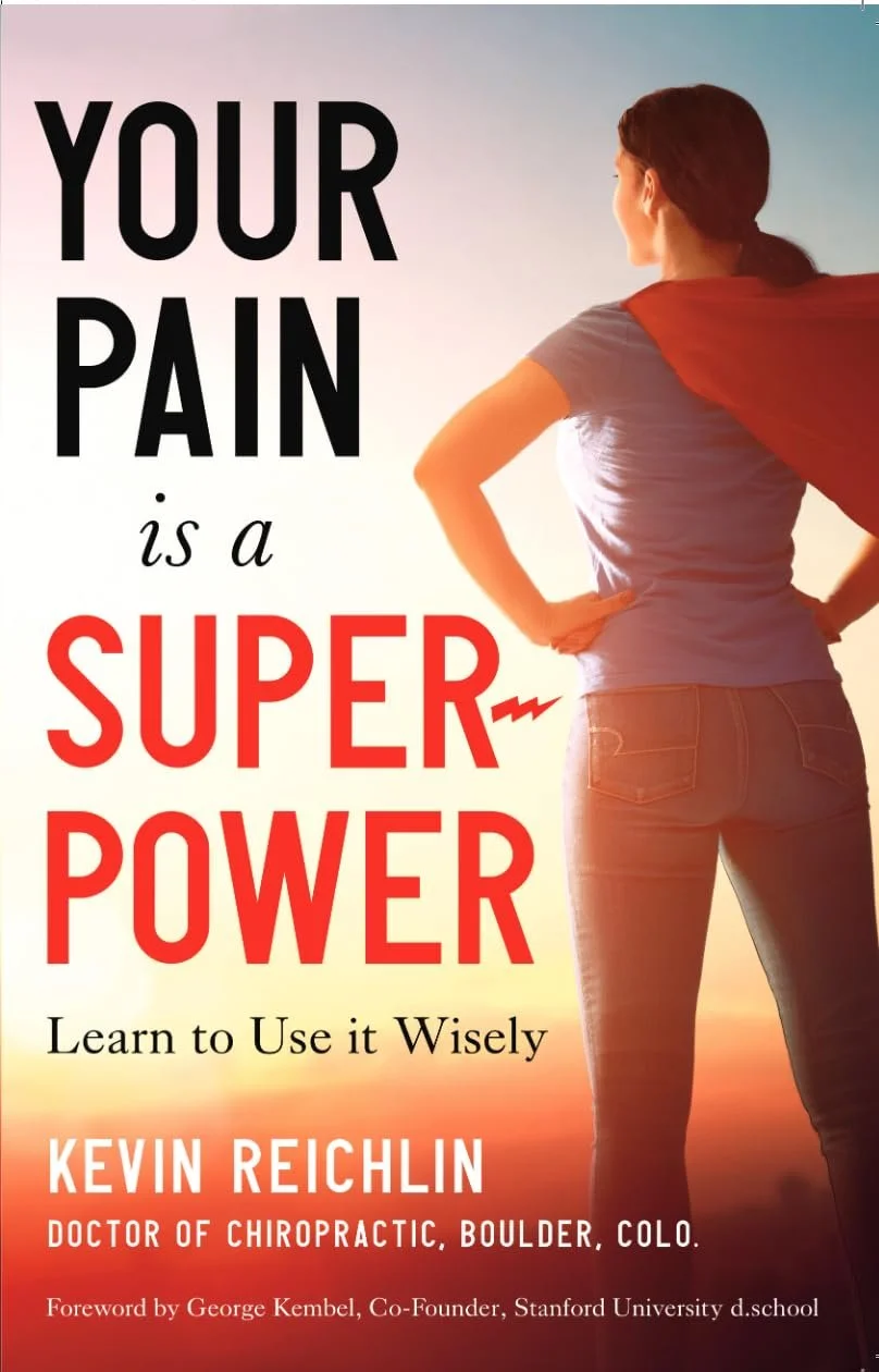 Book cover titled 'Your Pain is a Super Power' with a woman in a t-shirt and jeans looking at the sunset, wearing a red cape.