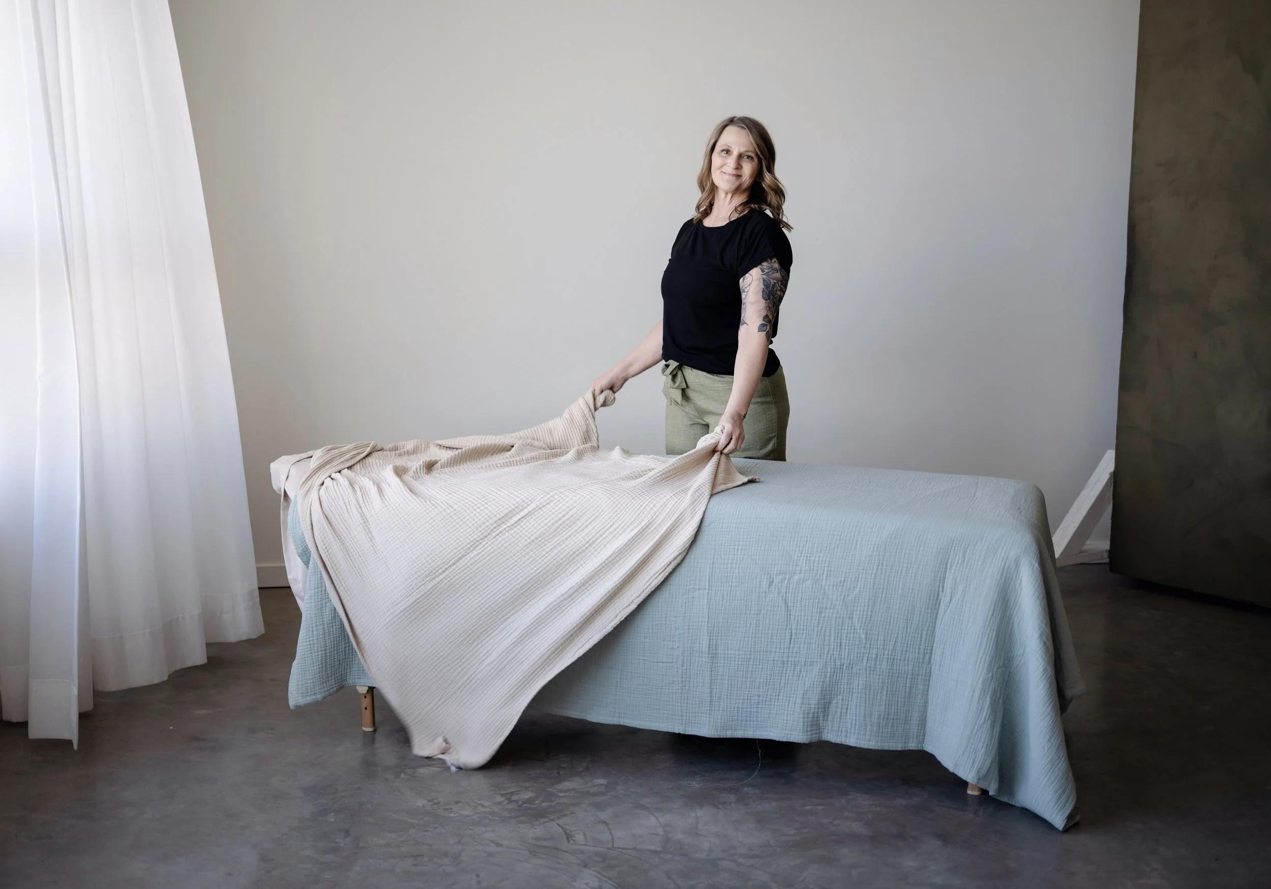 RMT Jacqueline Dupont at The Art of Rest setting up the massage table