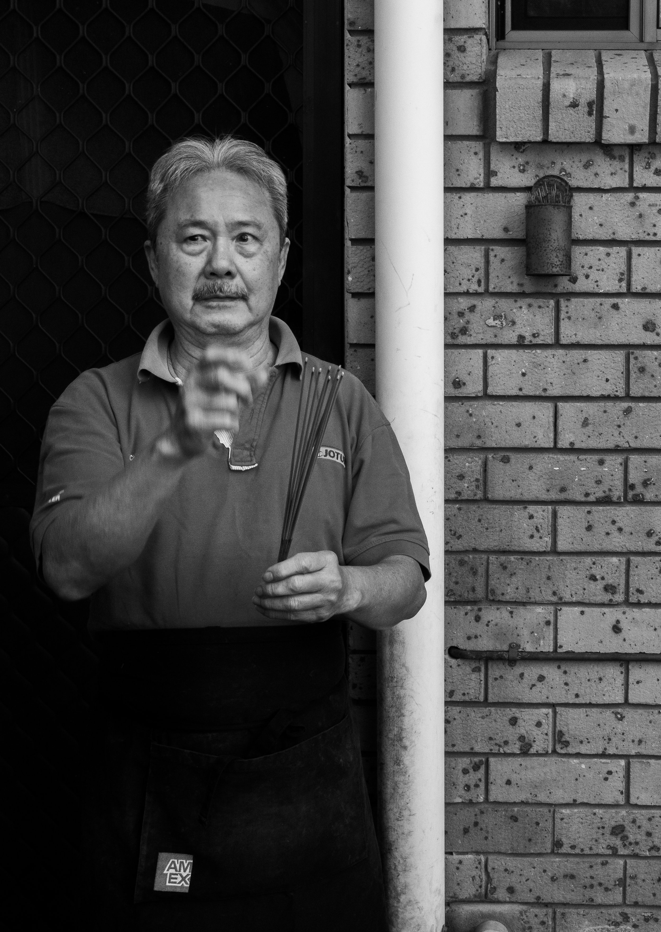 Francis is captured preparing and lighting incense to sit beside the back door of the kitchen, a ritual the couple have been doing fortnightly for 30 years. They tell me this is what has protected and provided for them.