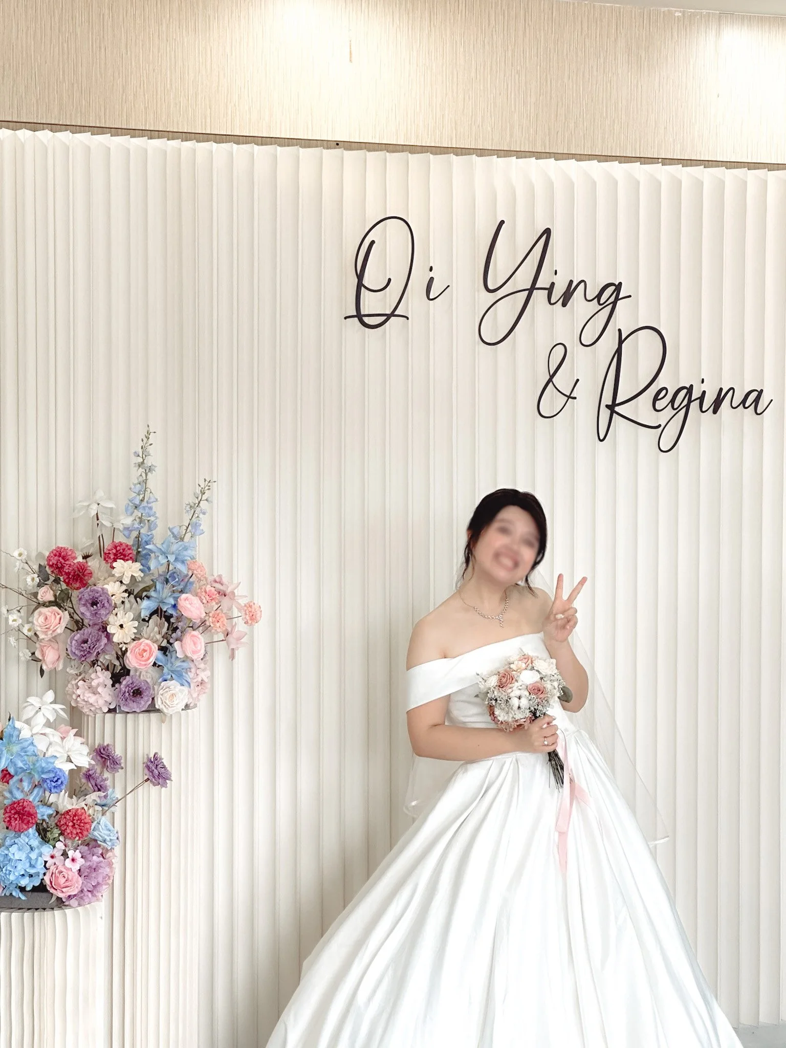 Pleated backdrop with customised faux florals for a church wedding reception and photobooth
