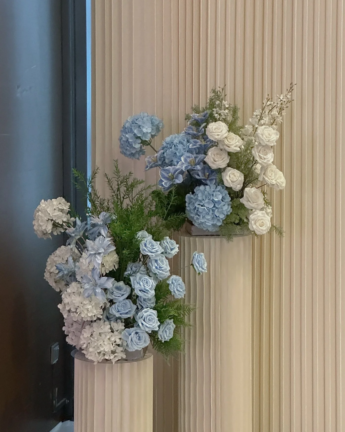 Pleated Backdrop with blue and white florals for a wedding photobooth in Singapore at One farrer hotel 