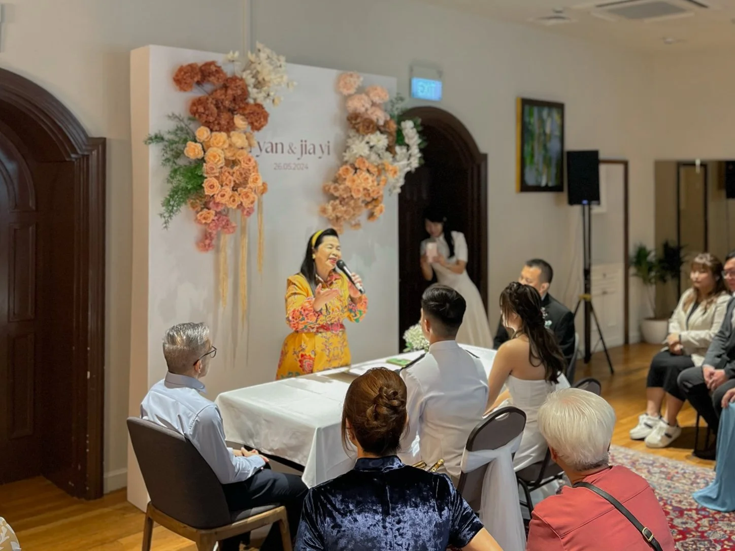 Wedding backdrop with faux floral flowers in Autumn colours for a wedding solemnisation ROM in Singapore at The Masons Table