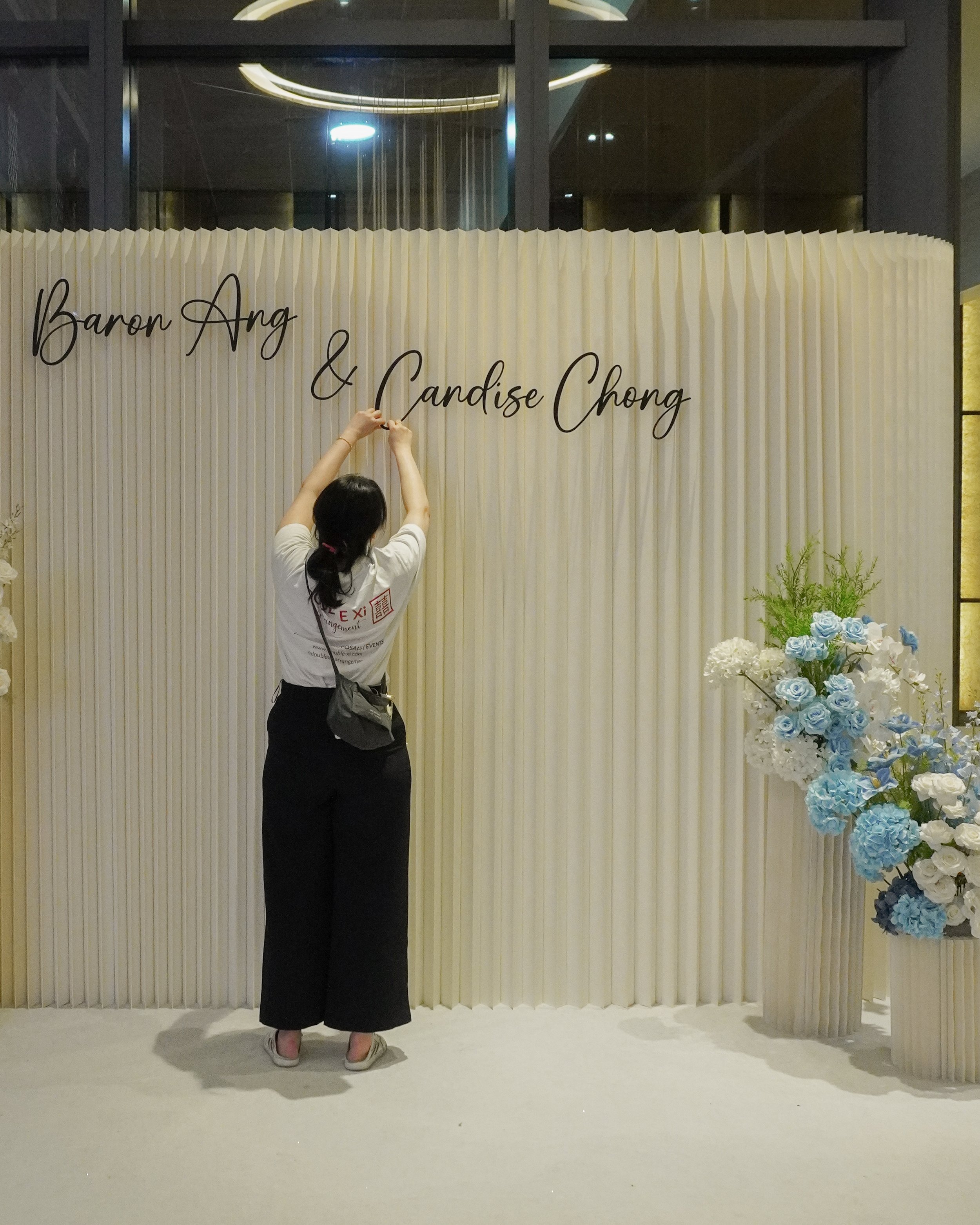 Pleated Backdrop with blue and white florals for a wedding photobooth in Singapore at One farrer hotel 