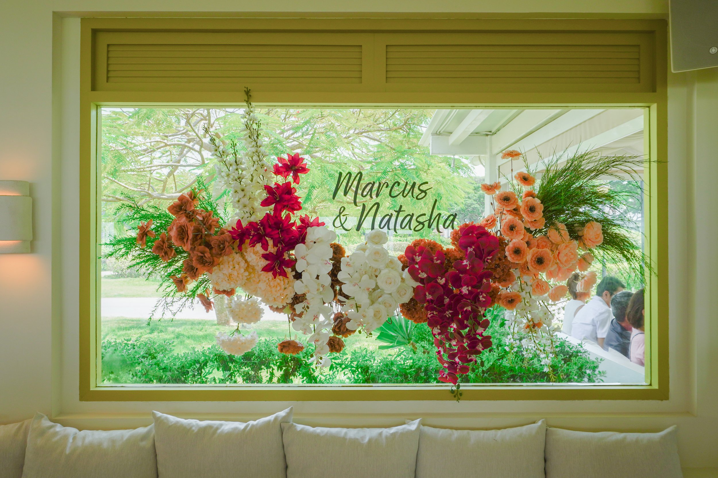 Faux floral arrangement and decal on window at Fico East Coast Park for a wedding celebration and photo spot