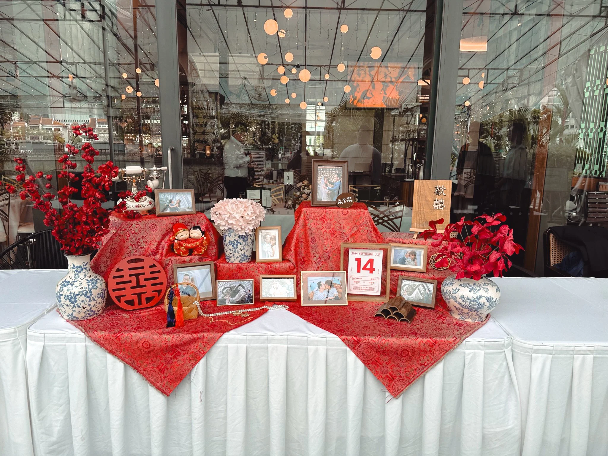 Traditional Oriental style table display photo display table for a wedding reception at Empress