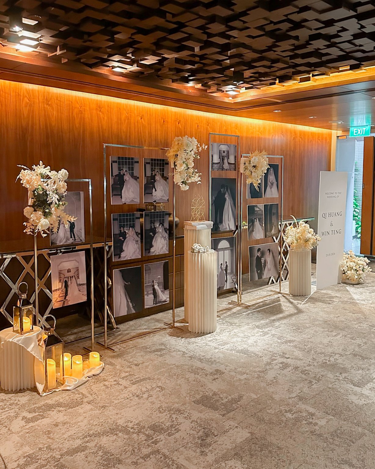 Gold photo gallery display stands for a wedding reception in champagne and white florals