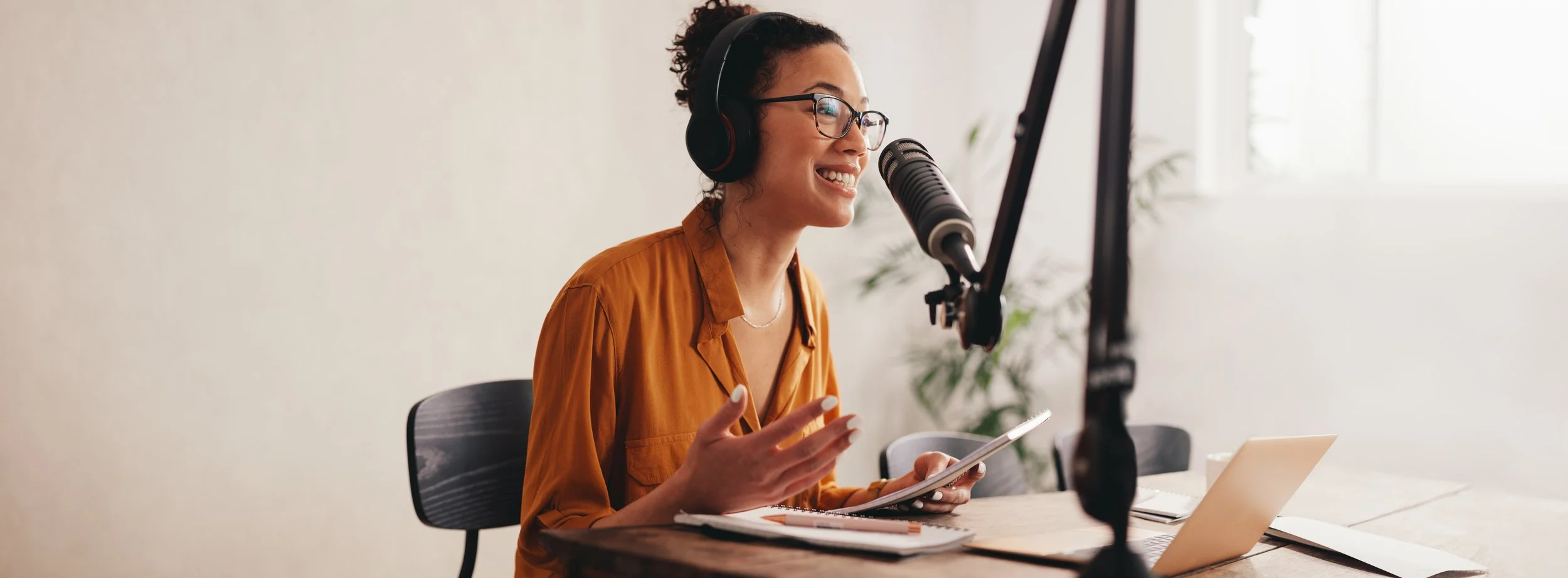 A person at a desk on a live podcast