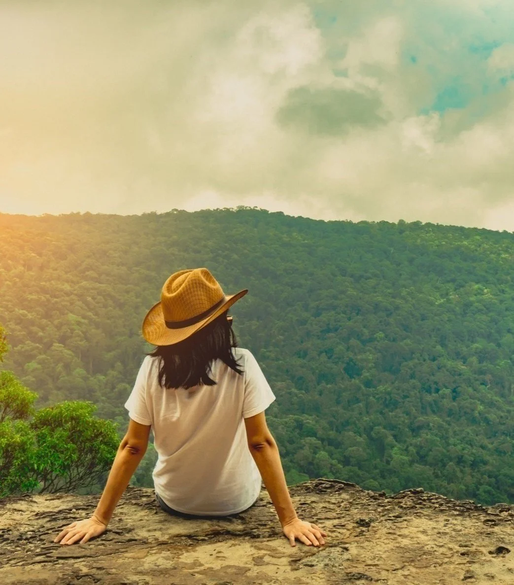 Woman sitting on mountain